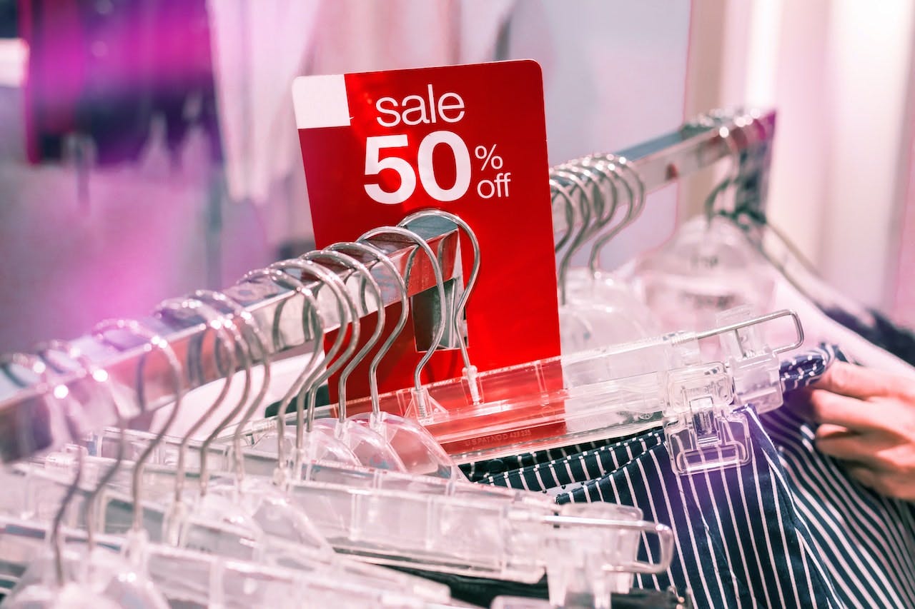 clothes rack with a sale sign