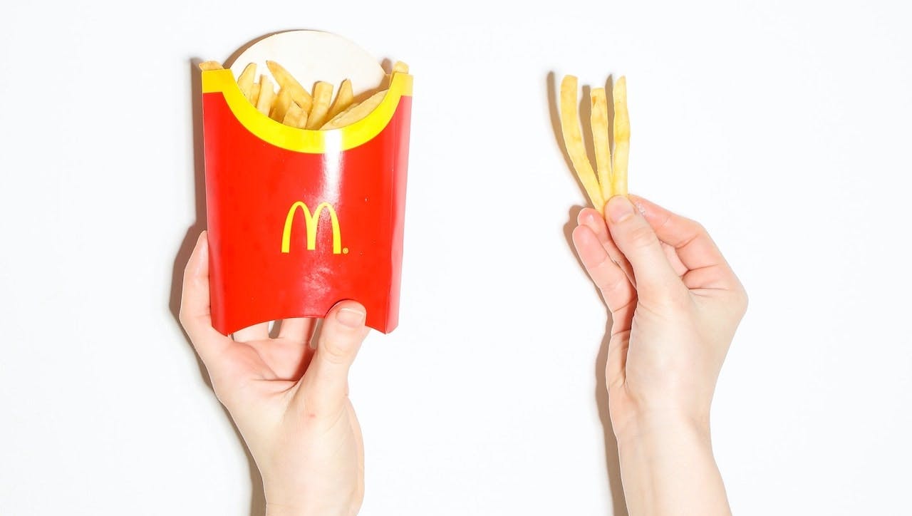 hands holding McDonald's french fries
