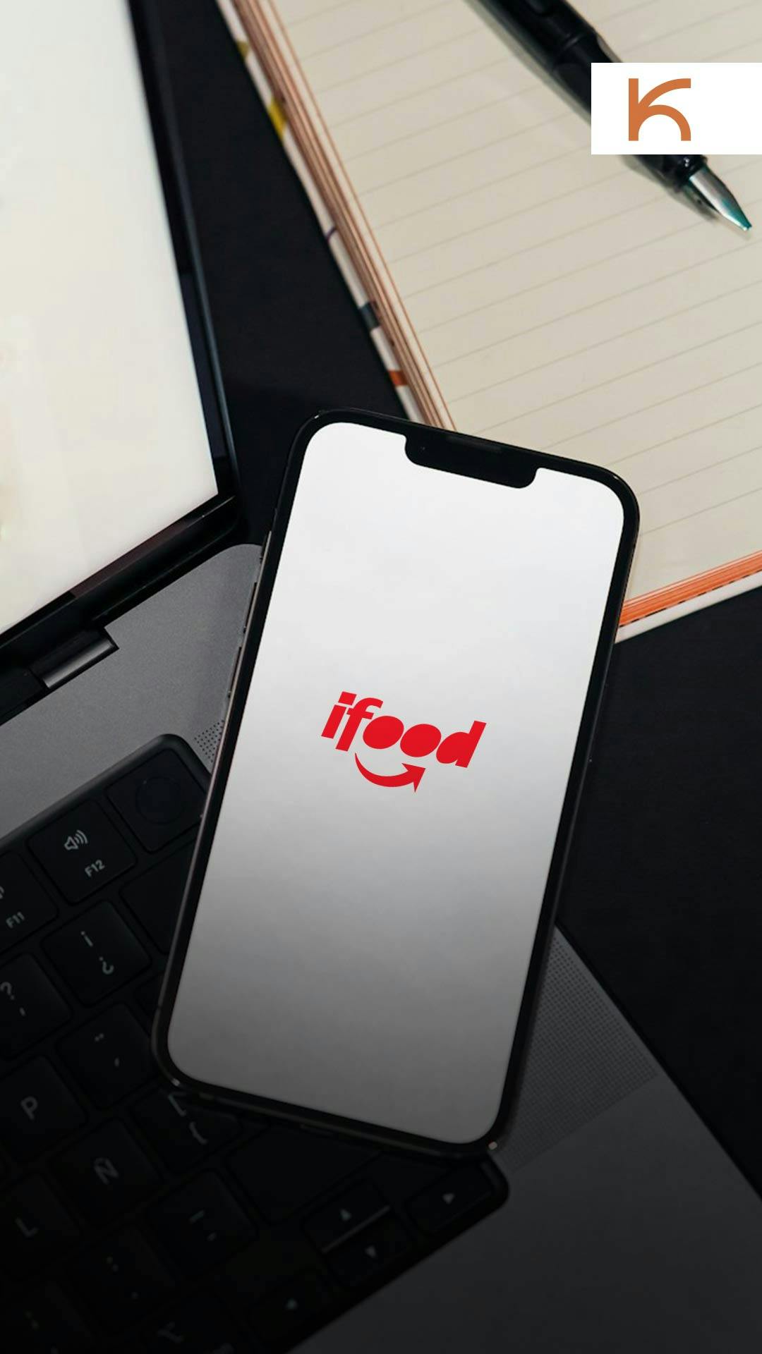 Setup profissional com smartphone sobre laptop, abrindo o gestor de pedidos ifood