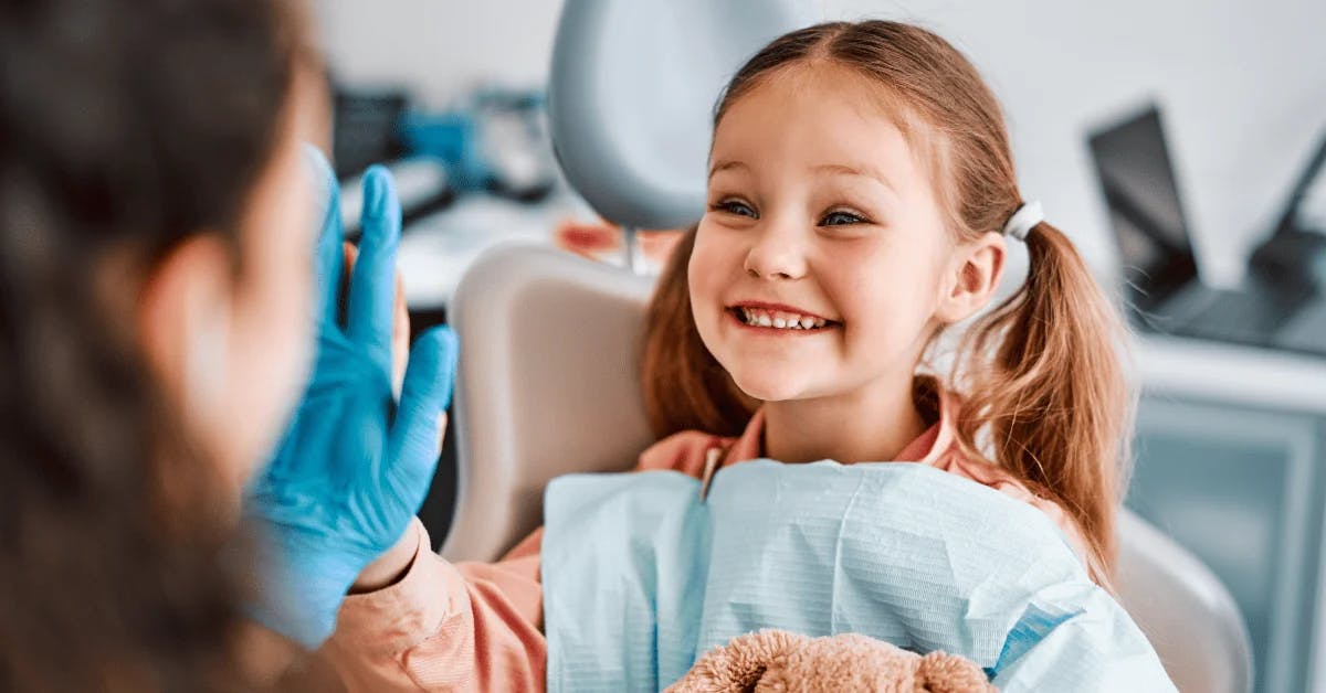 Young girl with dental big smiling at dentist.
