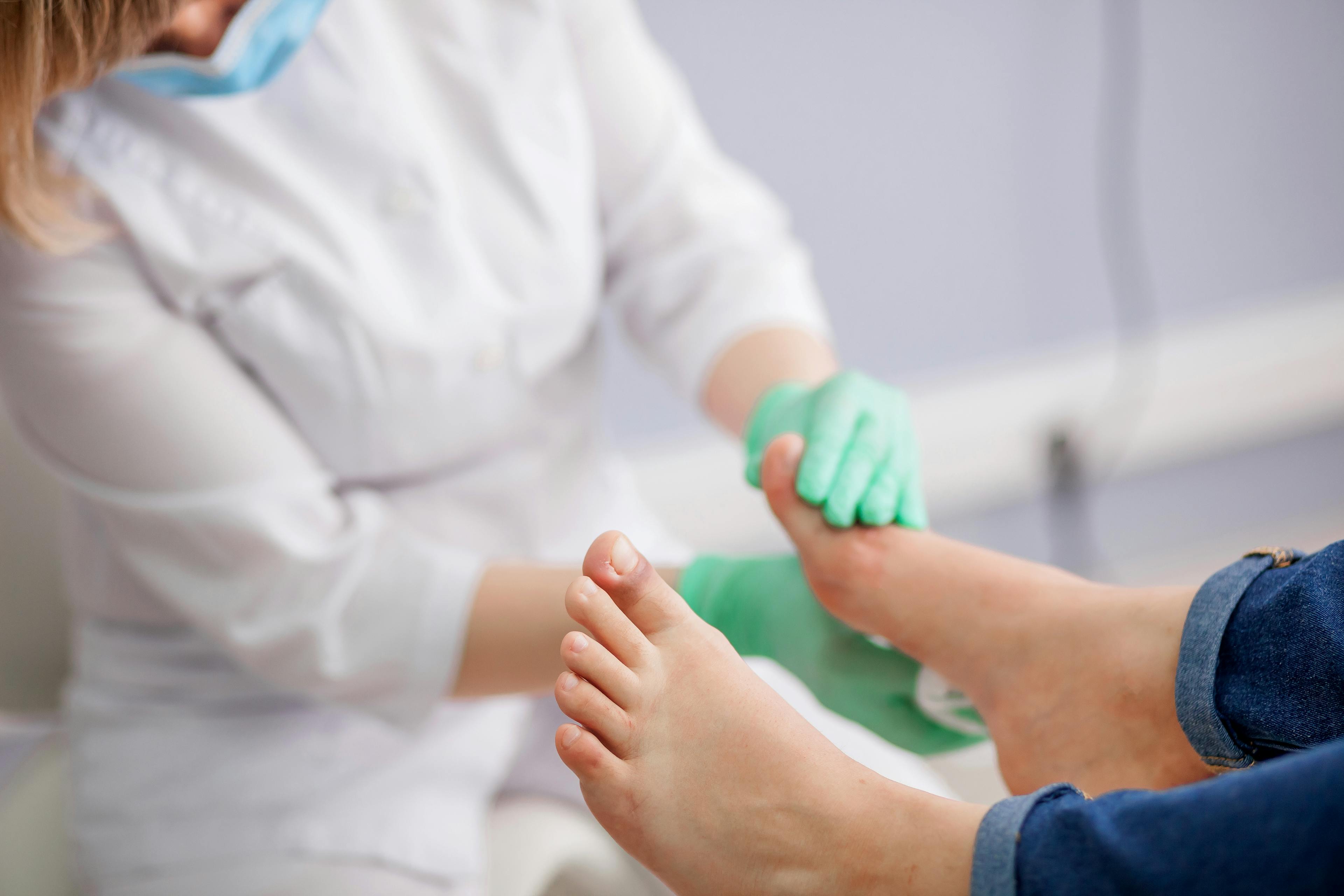 A podiatrist examining a patient's foot.