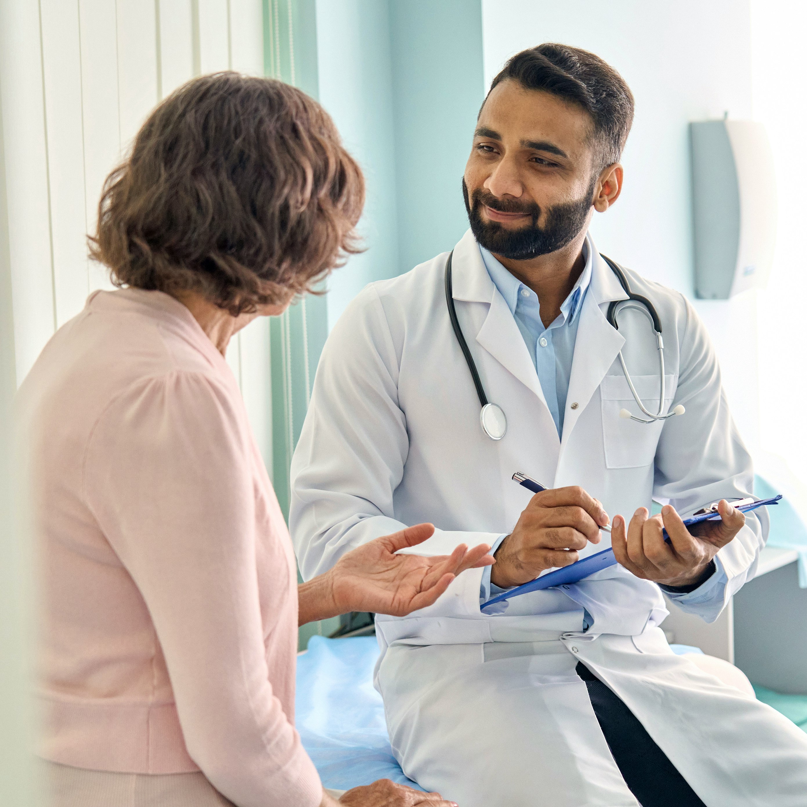 A heart specialist consulting with a female patient.