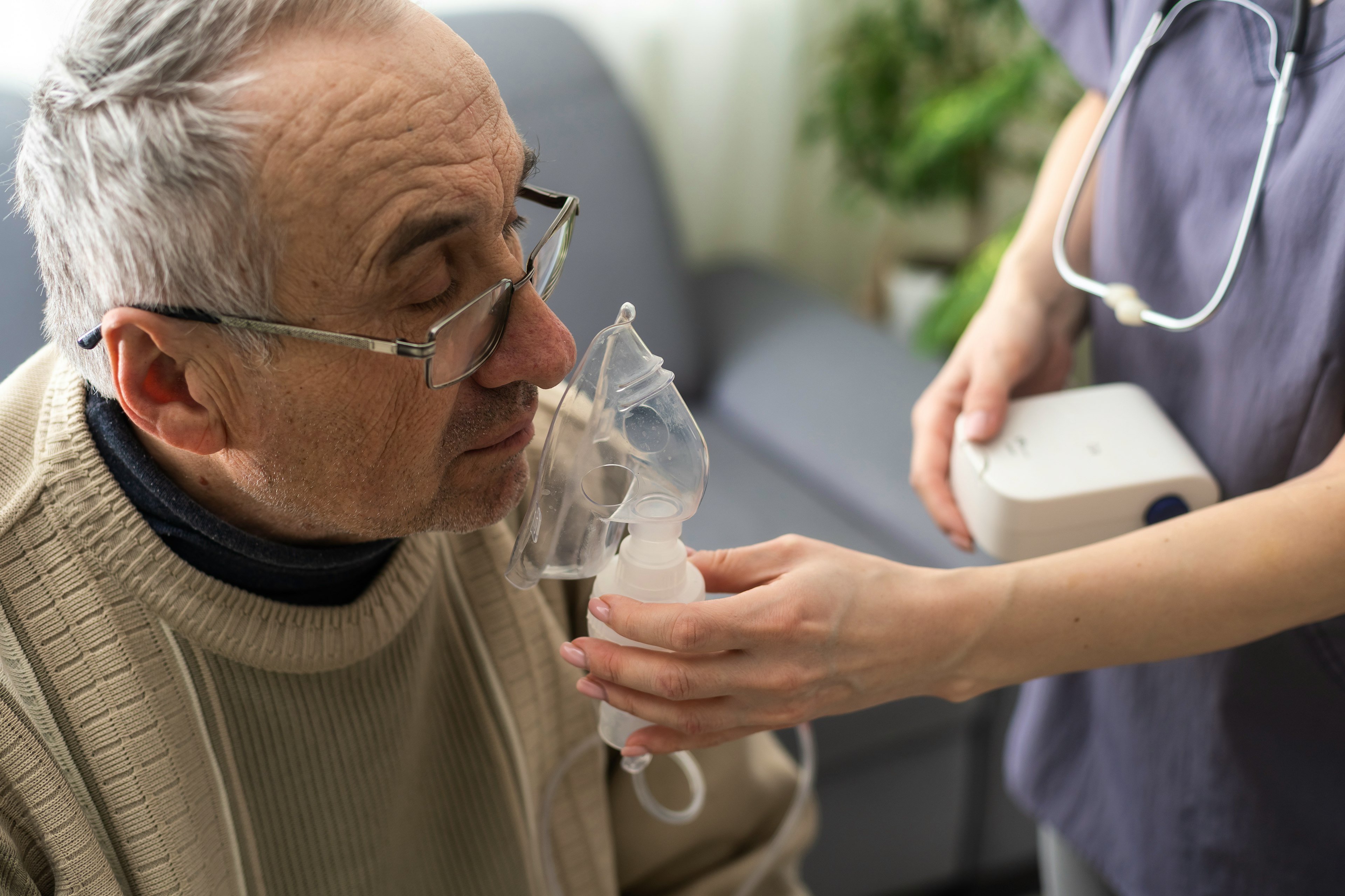 A healthcare provider placing a respirator on patient.