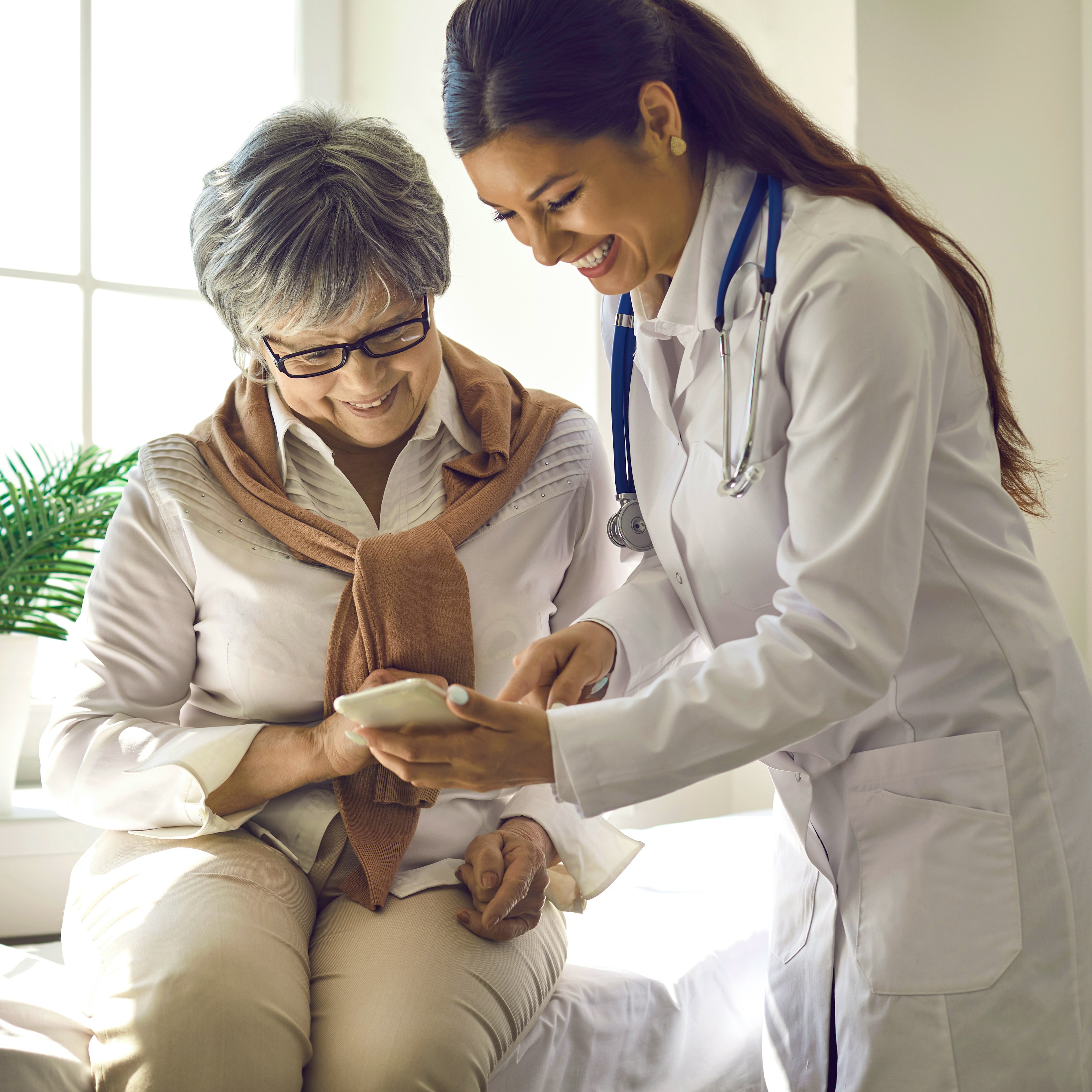 Internal medicine doctor assisting a patient during a consultation in a clinic.