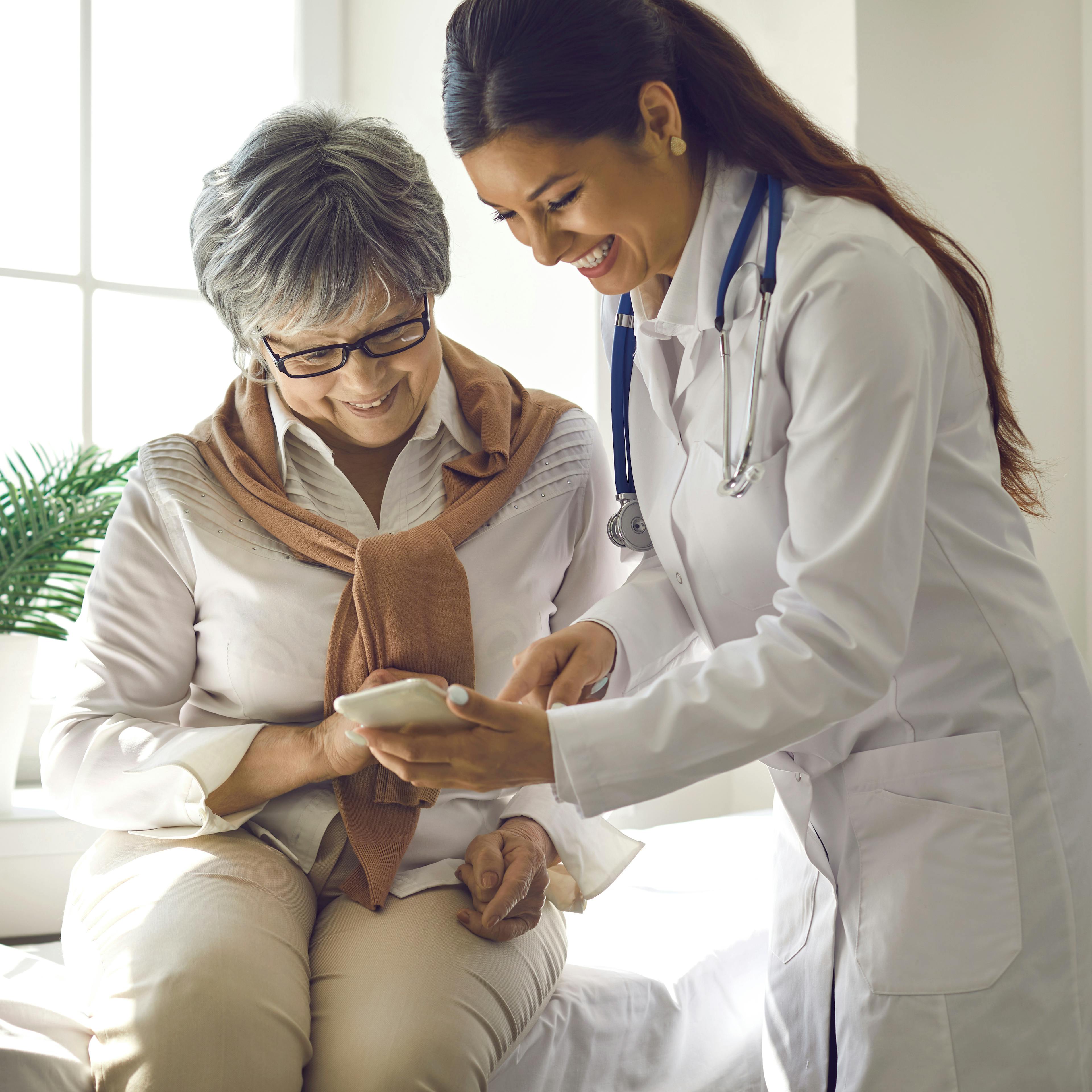 Internal medicine doctor assisting a patient during a consultation in a clinic.