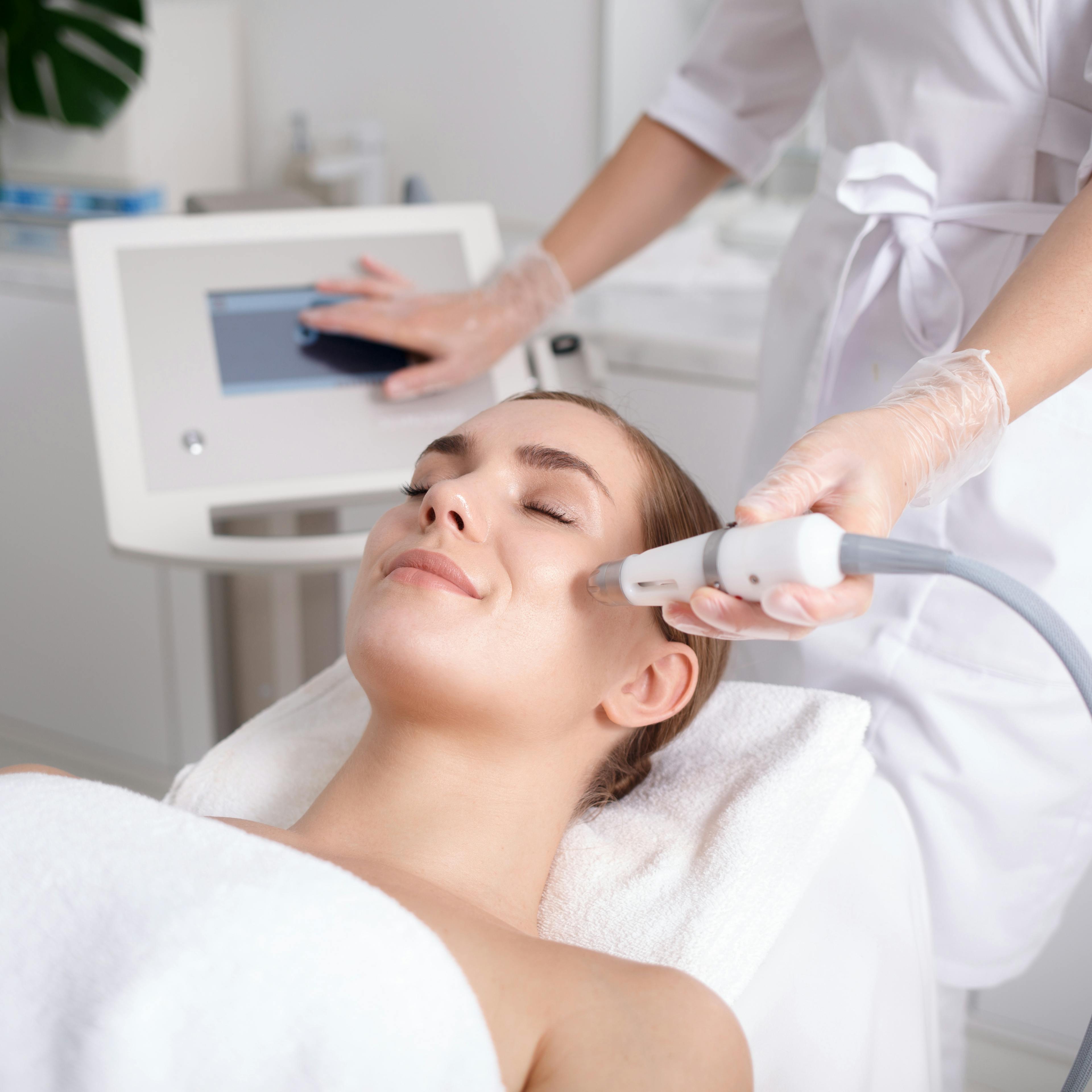 A patient is receiving cosmetic treatments from a medical professional. 