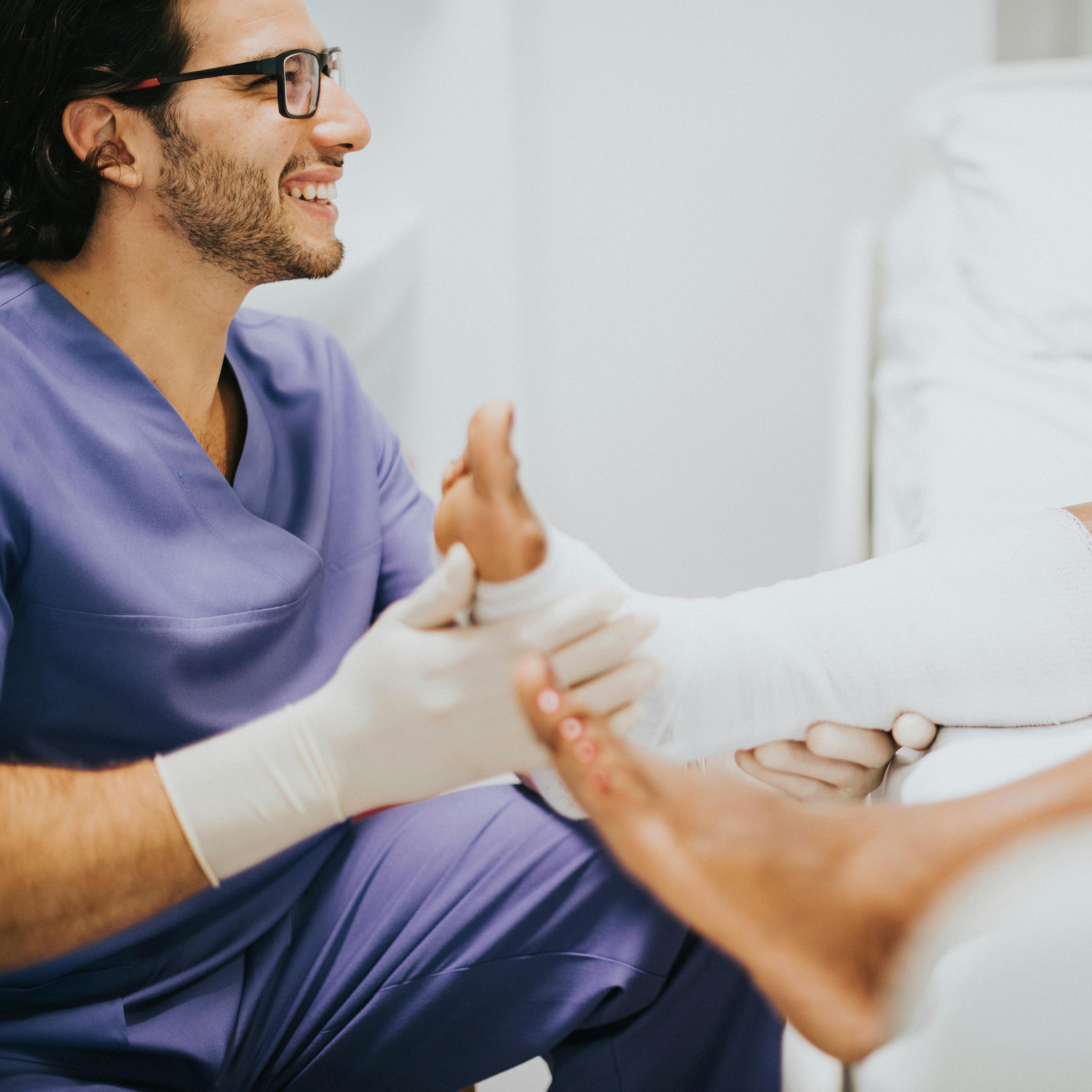 A podiatrist examines a patient's foot.