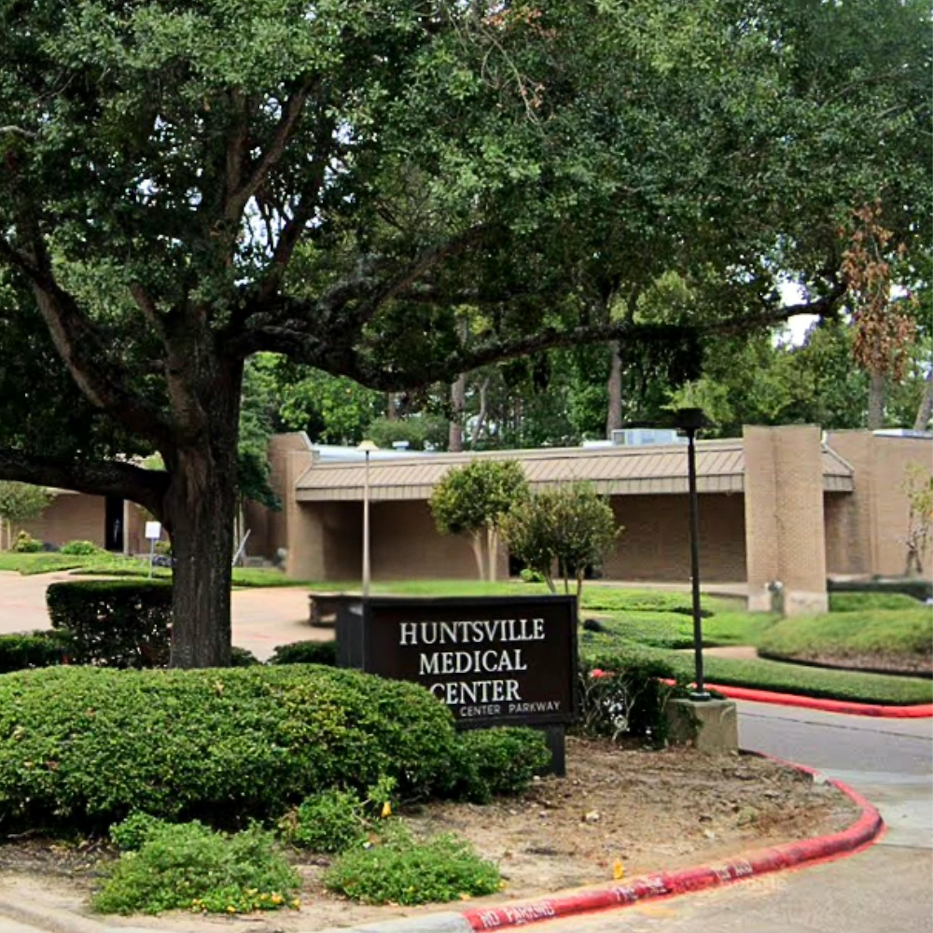 Exterior of CLS Health Rheumatology Associates clinic in Huntsville, TX, featuring main entrance and building signage.