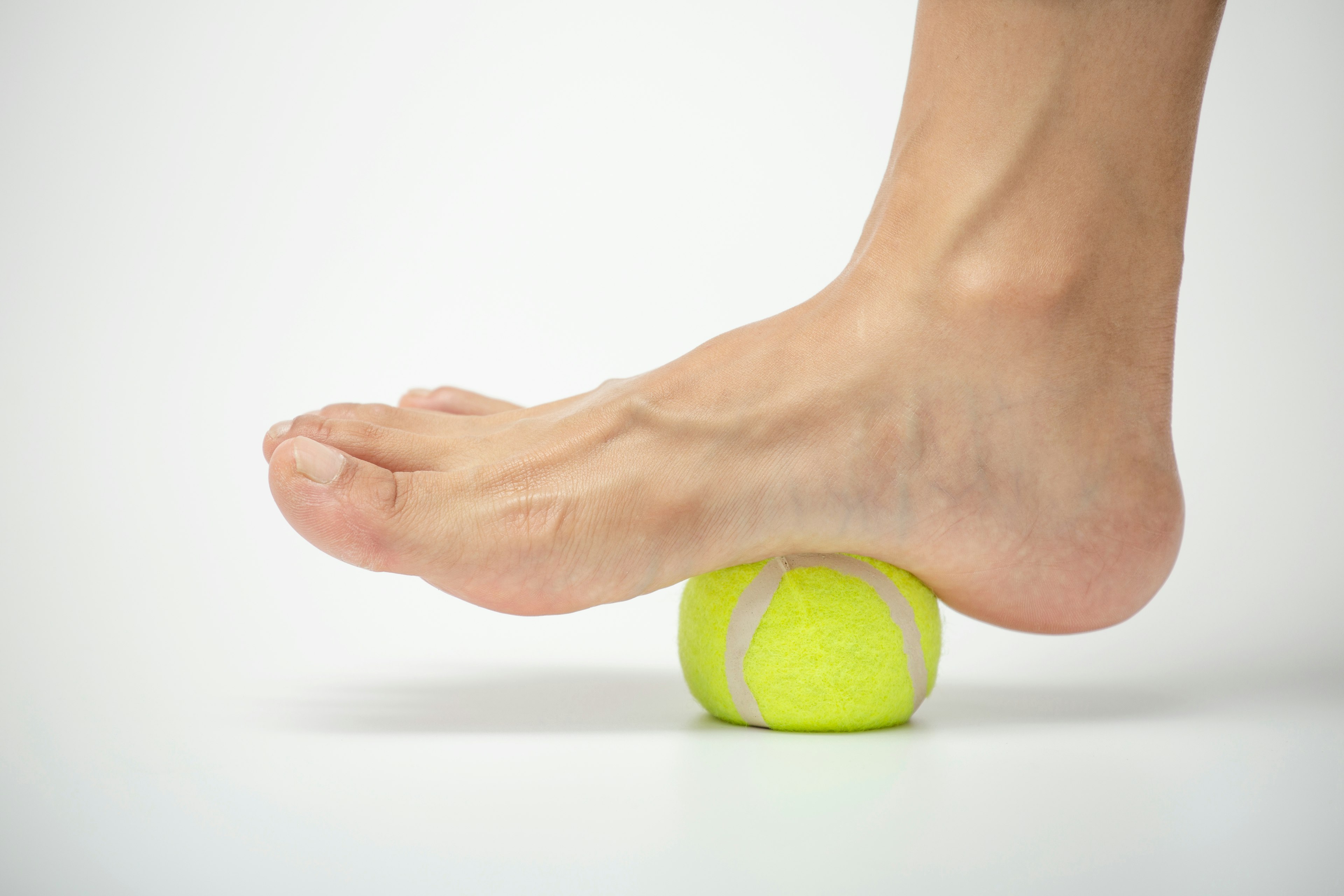Tennis ball roll massage for plantar fascia stretch.