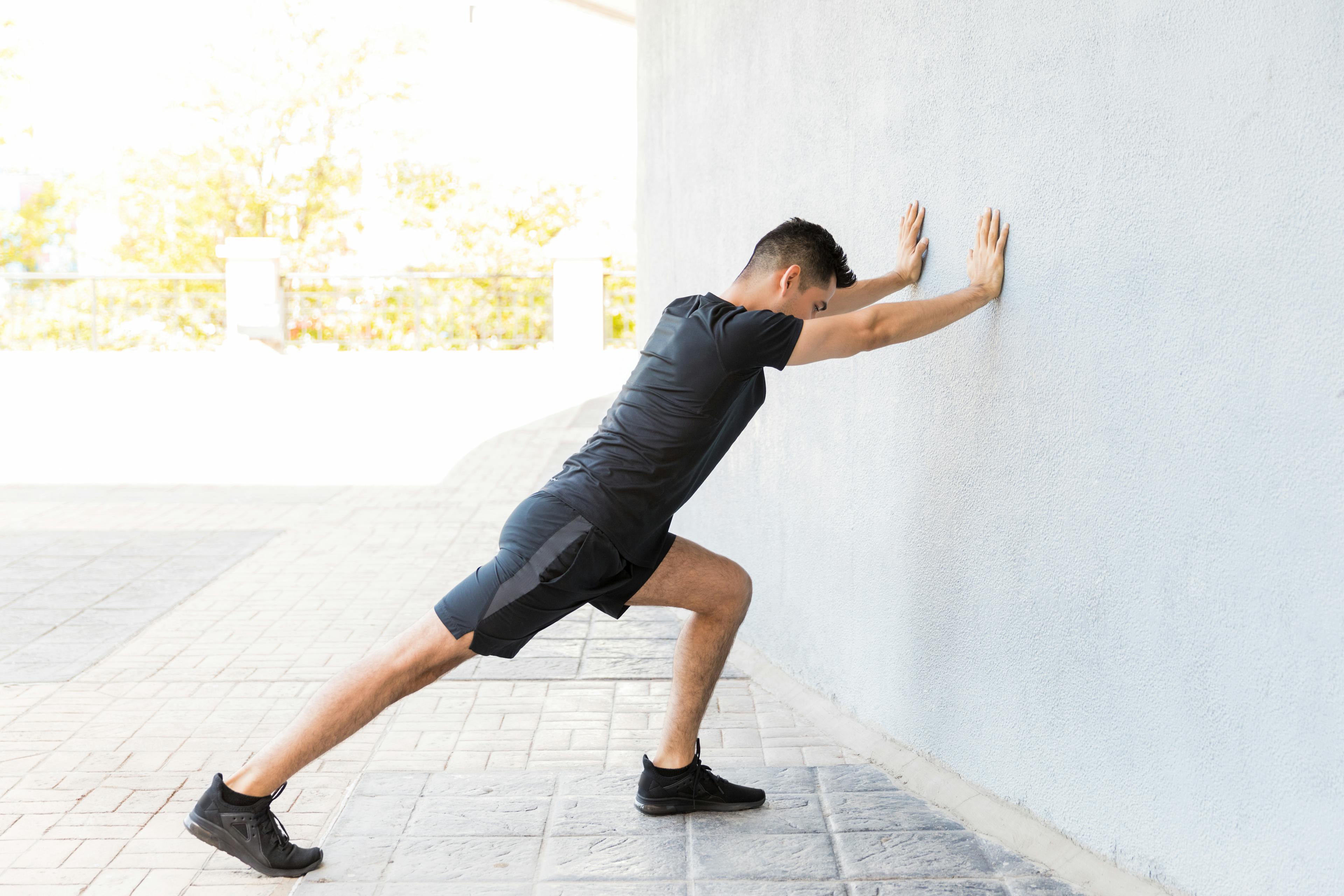 demonstration of calf stretch for plantar fasciitis.