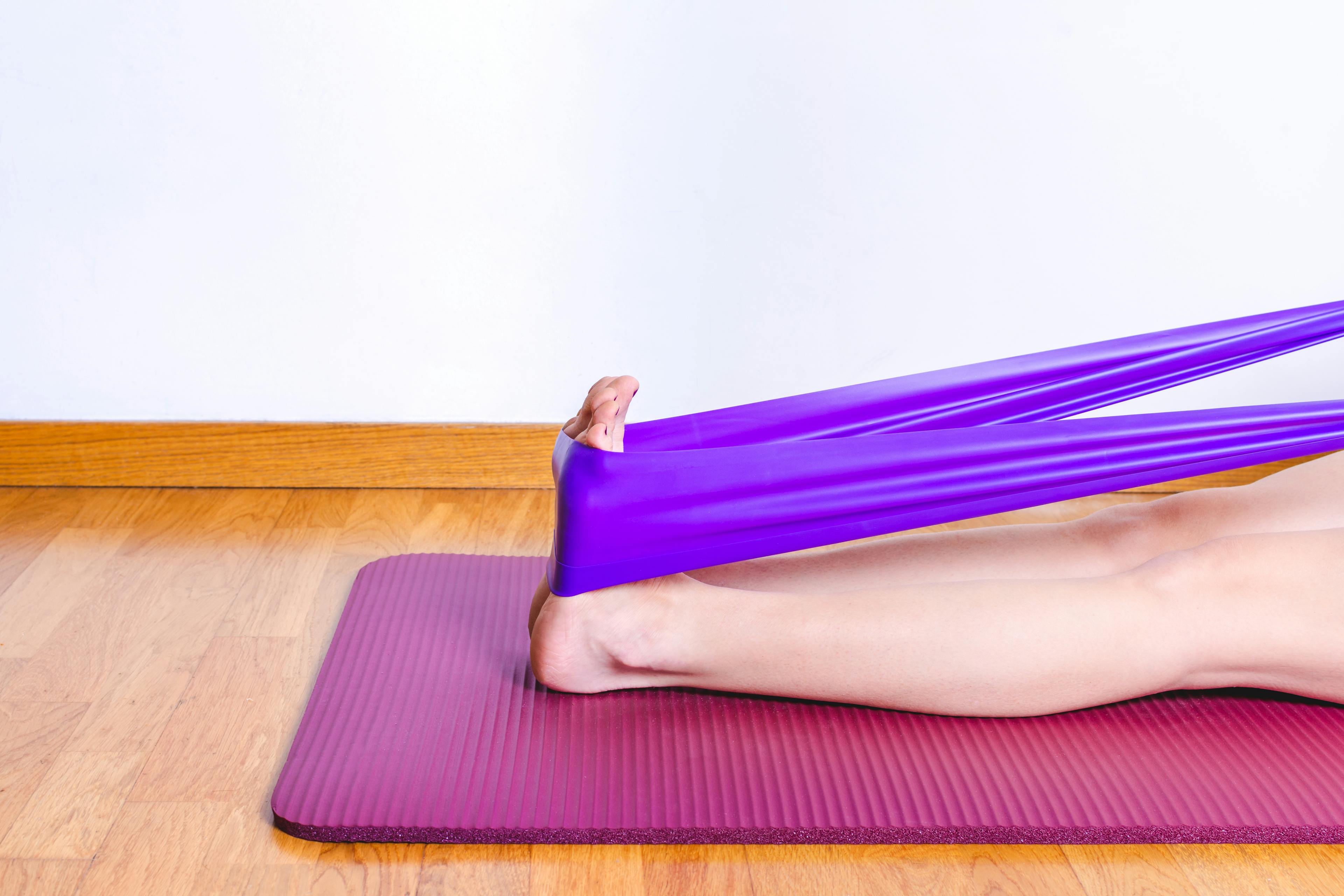 Demonstration of stretch with resistance band for plantar fasciitis.