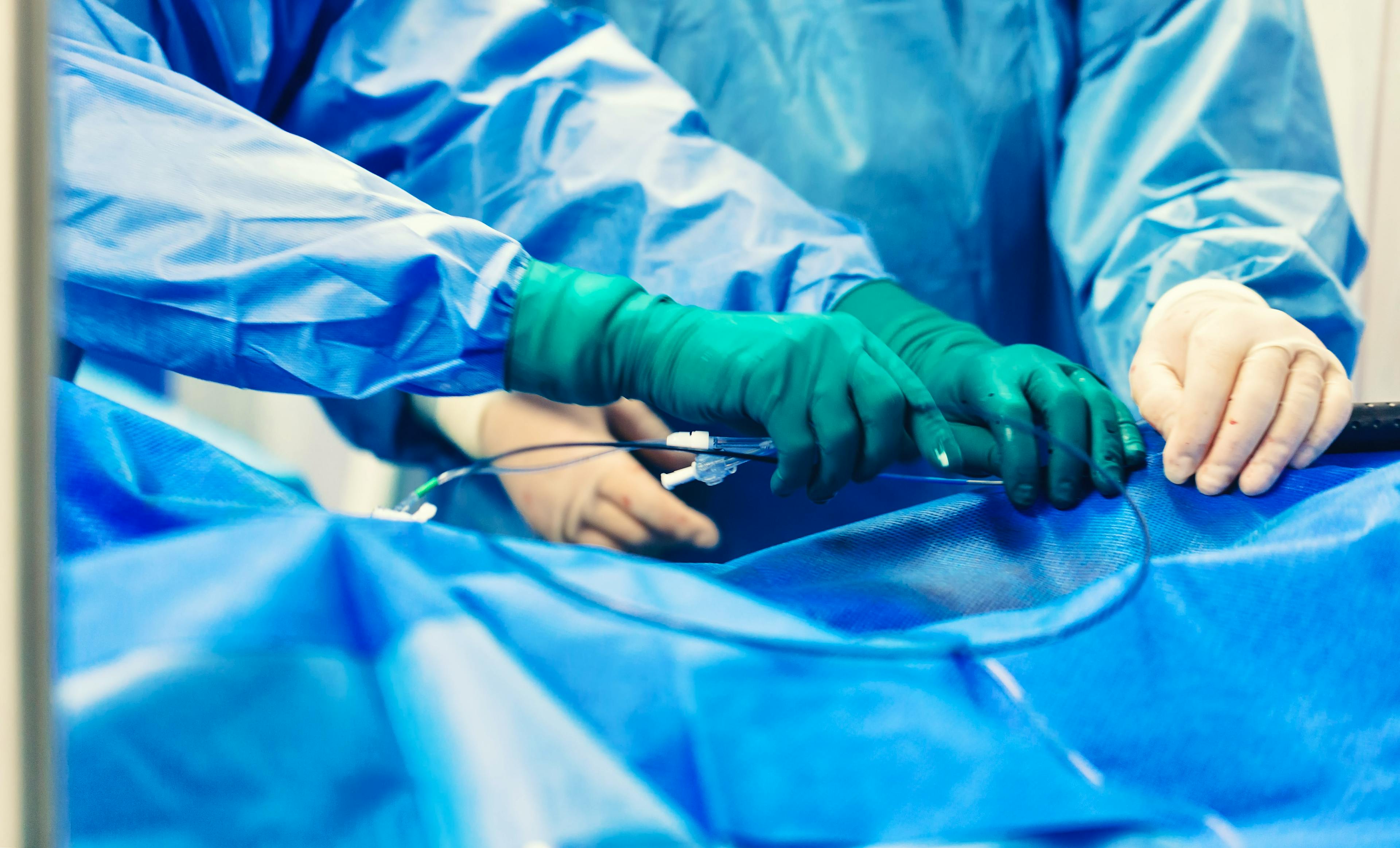 Team of cardiologist minimally invasive cardiology transcatheter closure treatment for patent foramen ovale PFO defects with occluder, using a endovascular procedure with cardiovascular imaging system.