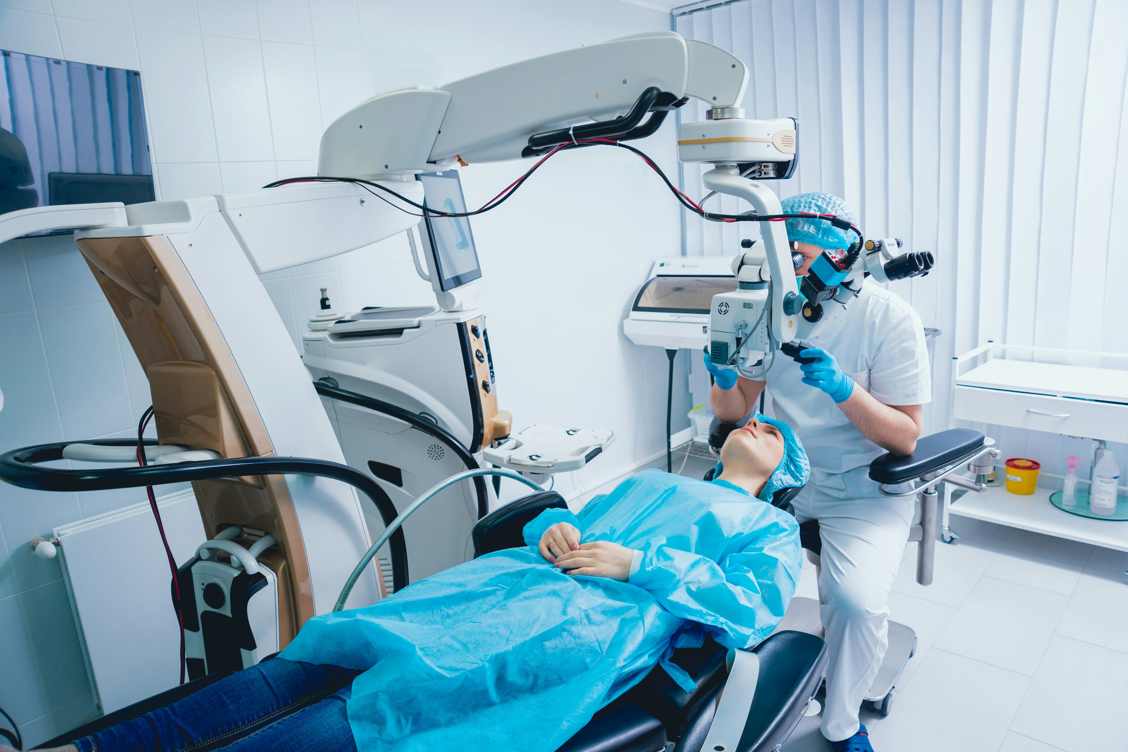 A patient and surgeon in the operating room during vision correction surgery.
