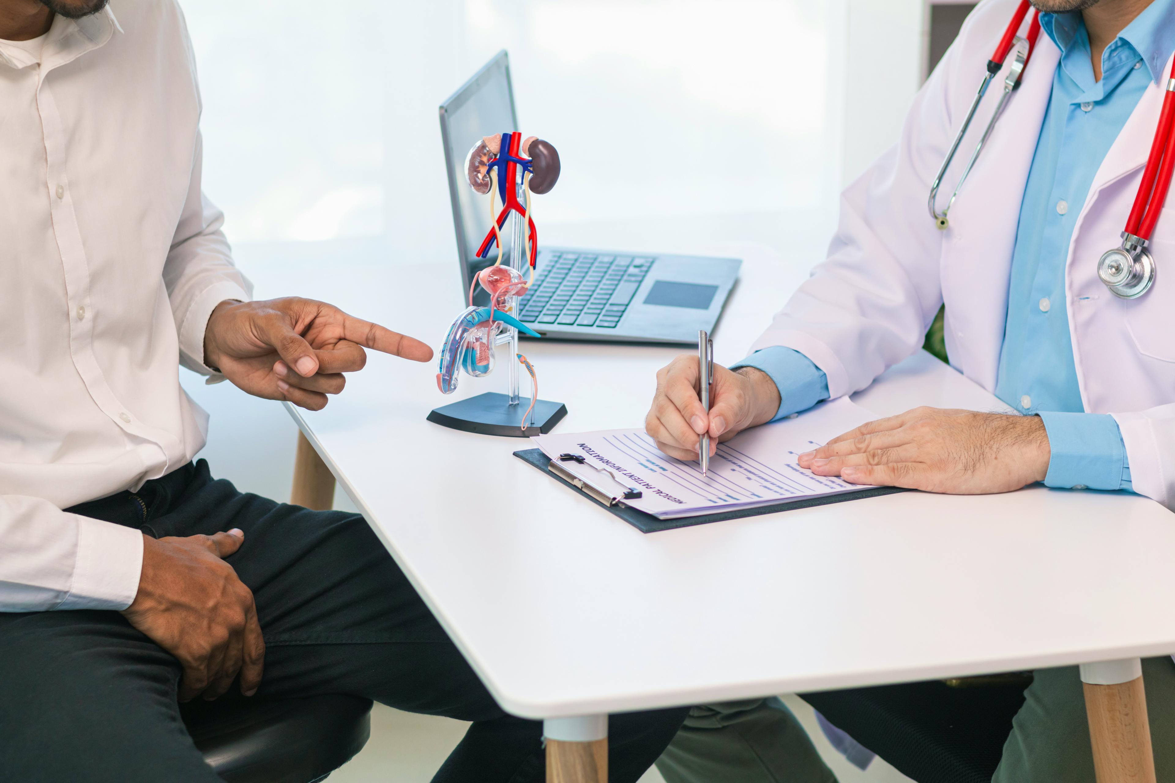 Man consulting with doctor on testicle problem.