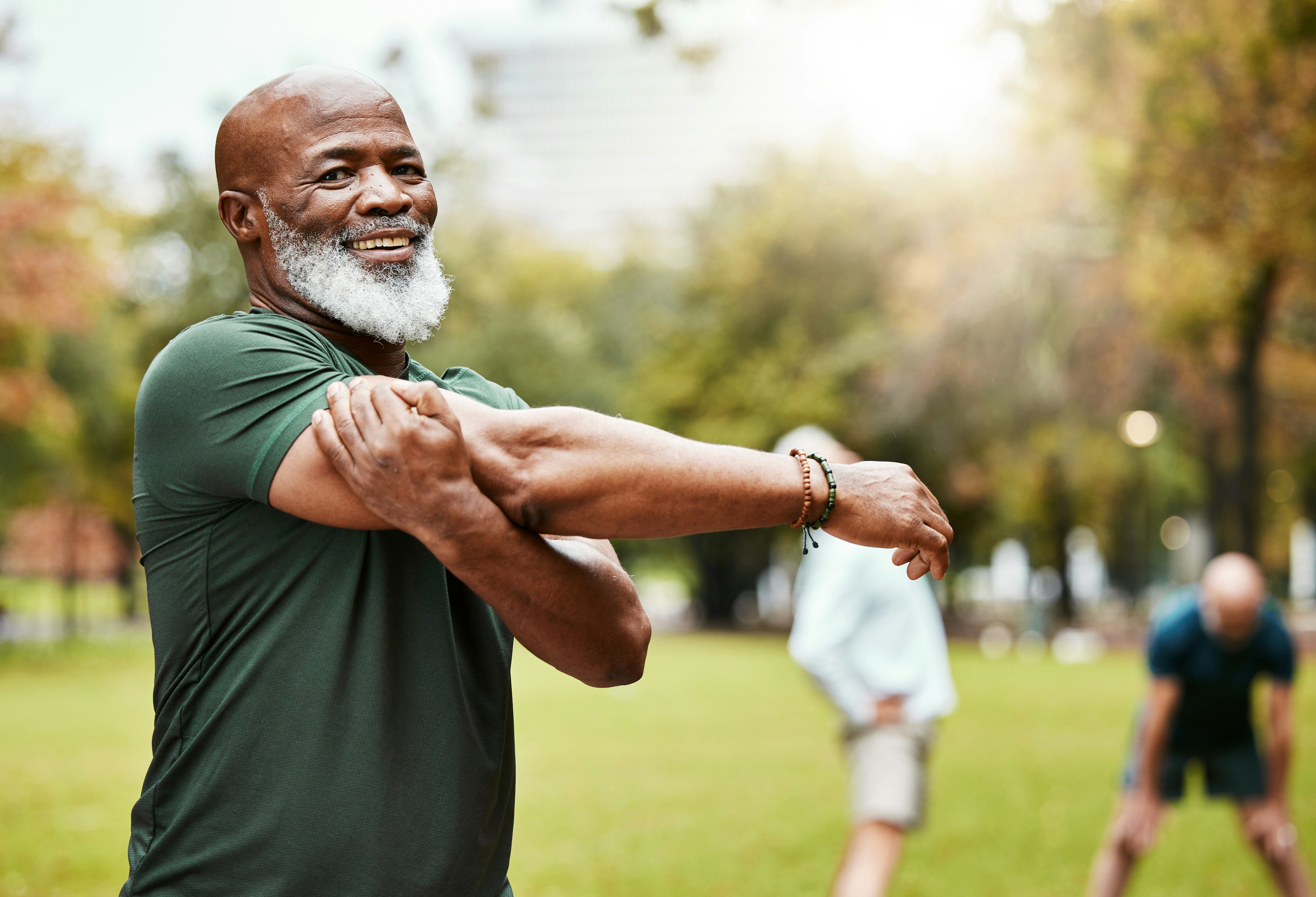 Older man stretching his arms.