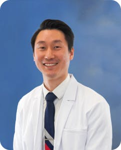 Board-certified cardiologist, Dr. Abraham Lee, pictured in his white coat.