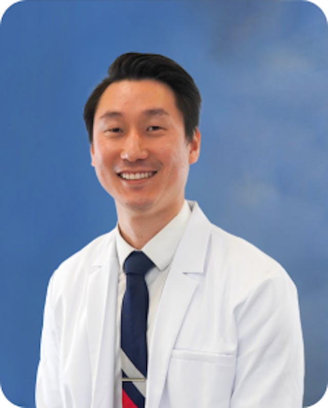 Board-certified cardiologist, Dr. Abraham Lee, pictured in his white coat. 