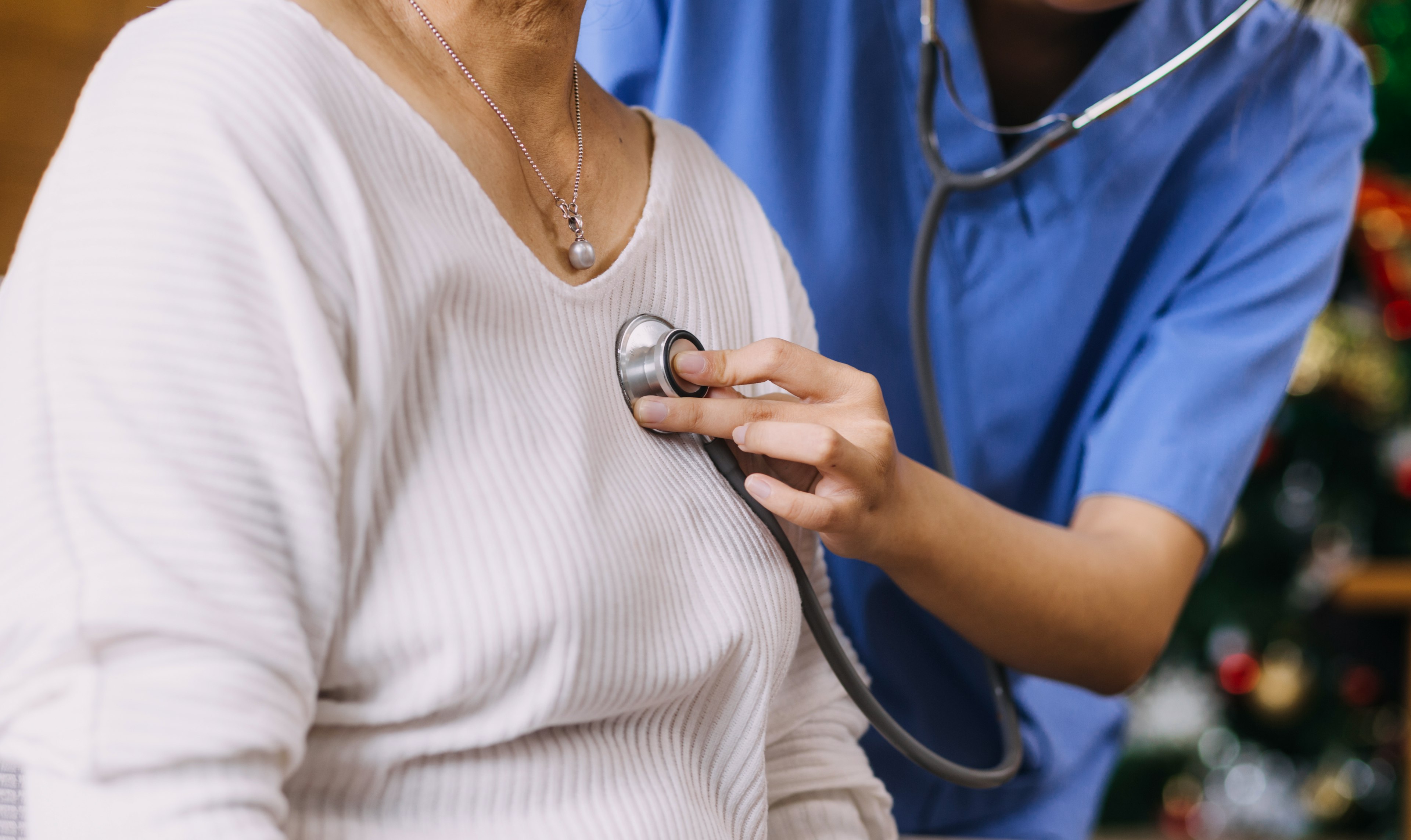 Doctor using a stethoscope on elderly patient