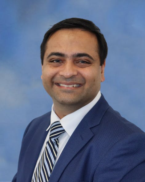 Neurology hospitalist, Kinjal Desai, MD, posing for his headshot.