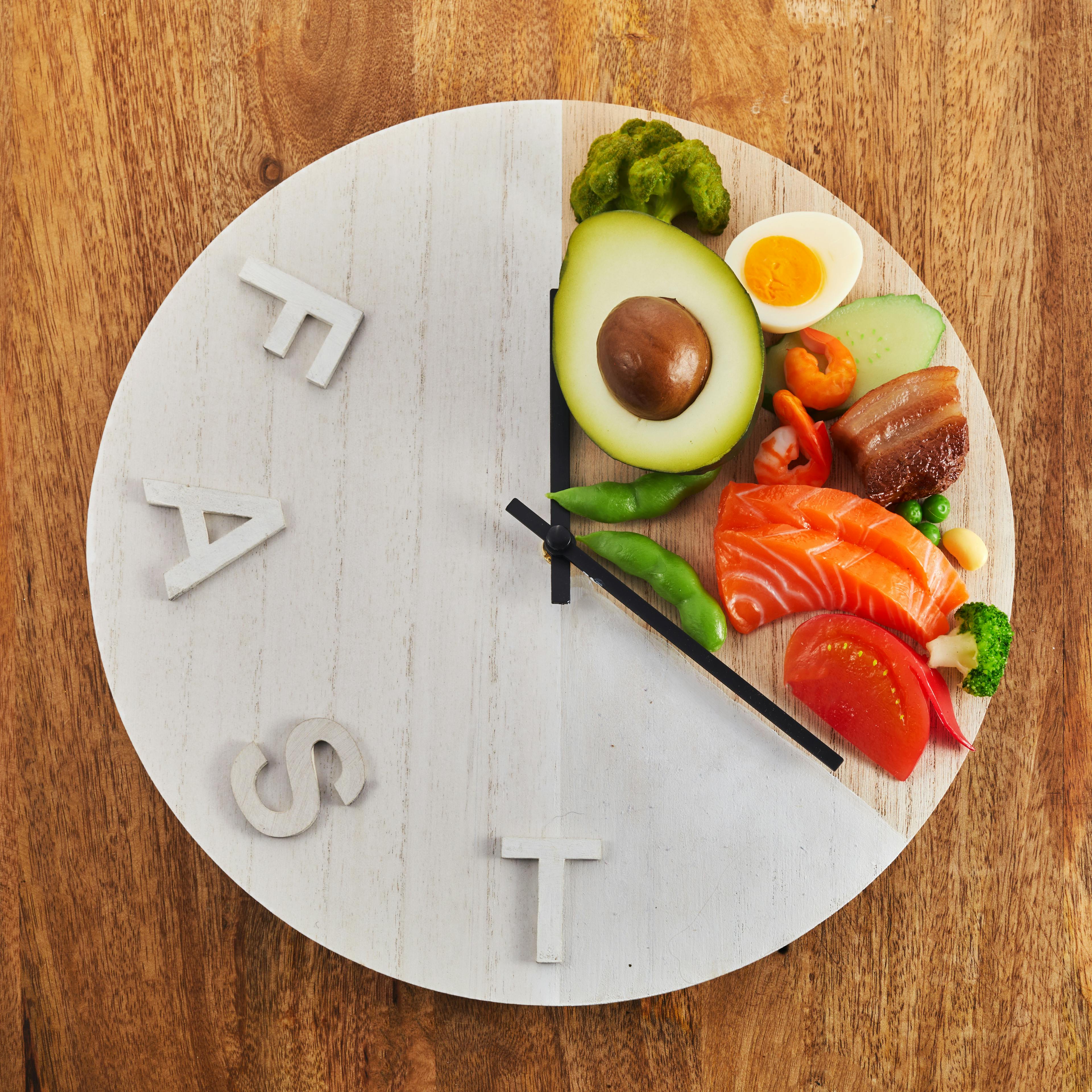 Photo food portioned on a plate to resemble a clock, representing intermittent fasting. 