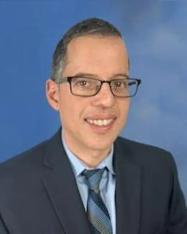 Interventional cardiologist, Fethi Benraouane, posing for his headshot.
