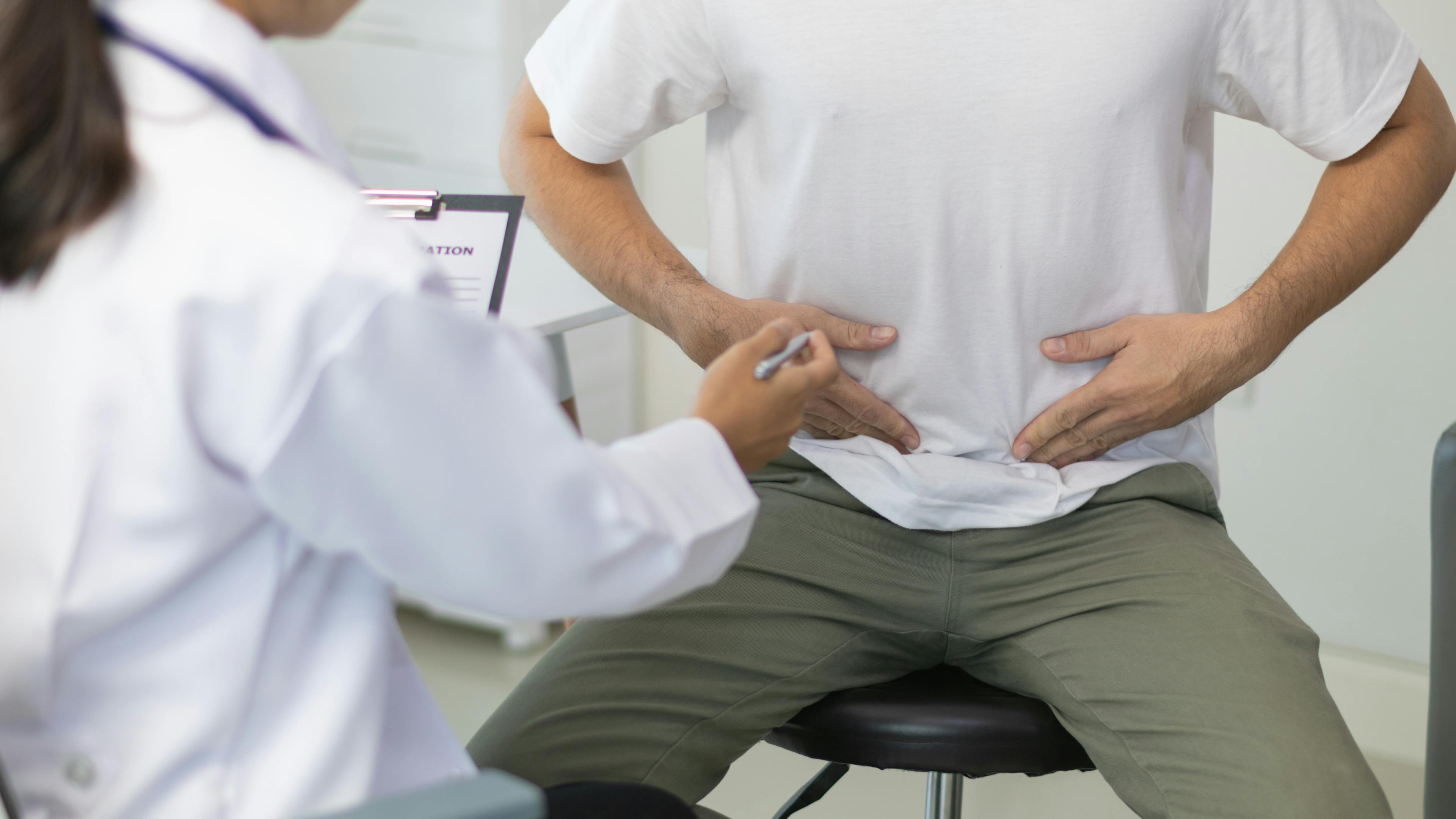 Male patient consulting with doctor about erectile dysfunction.