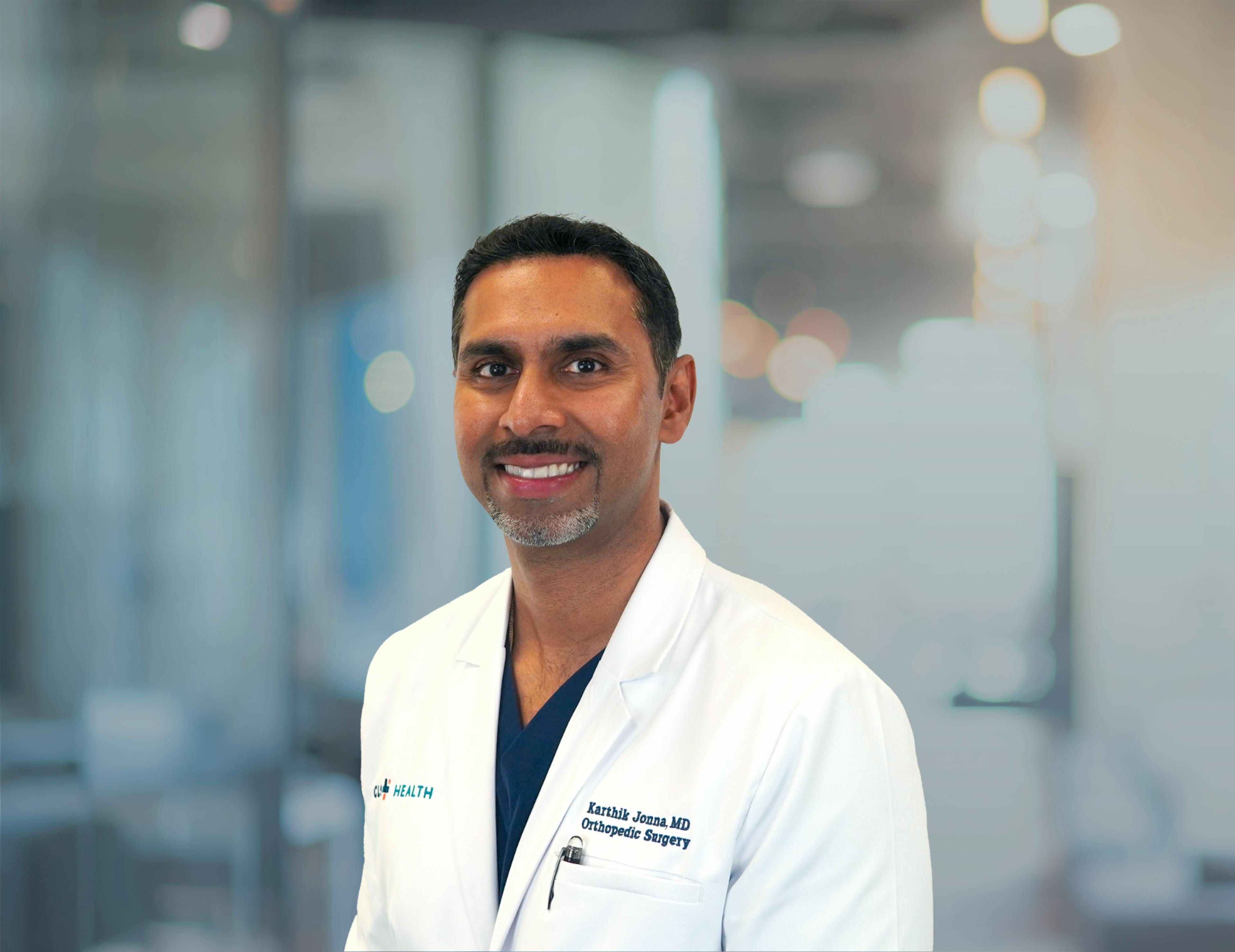 Karthik Jonna, MD, pictured in his white coat for a headshot.