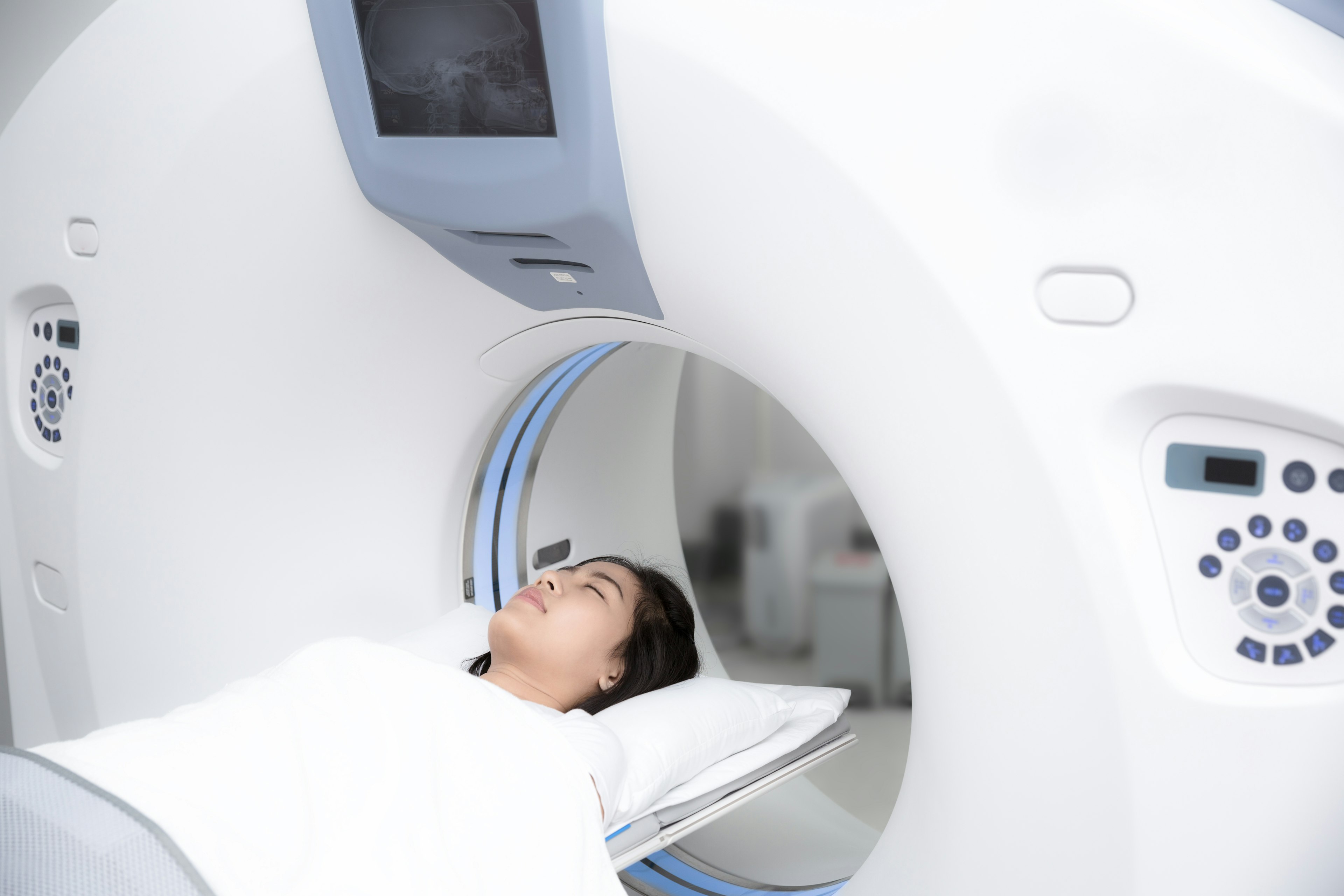Female patient lying on a CT Scan bed.
