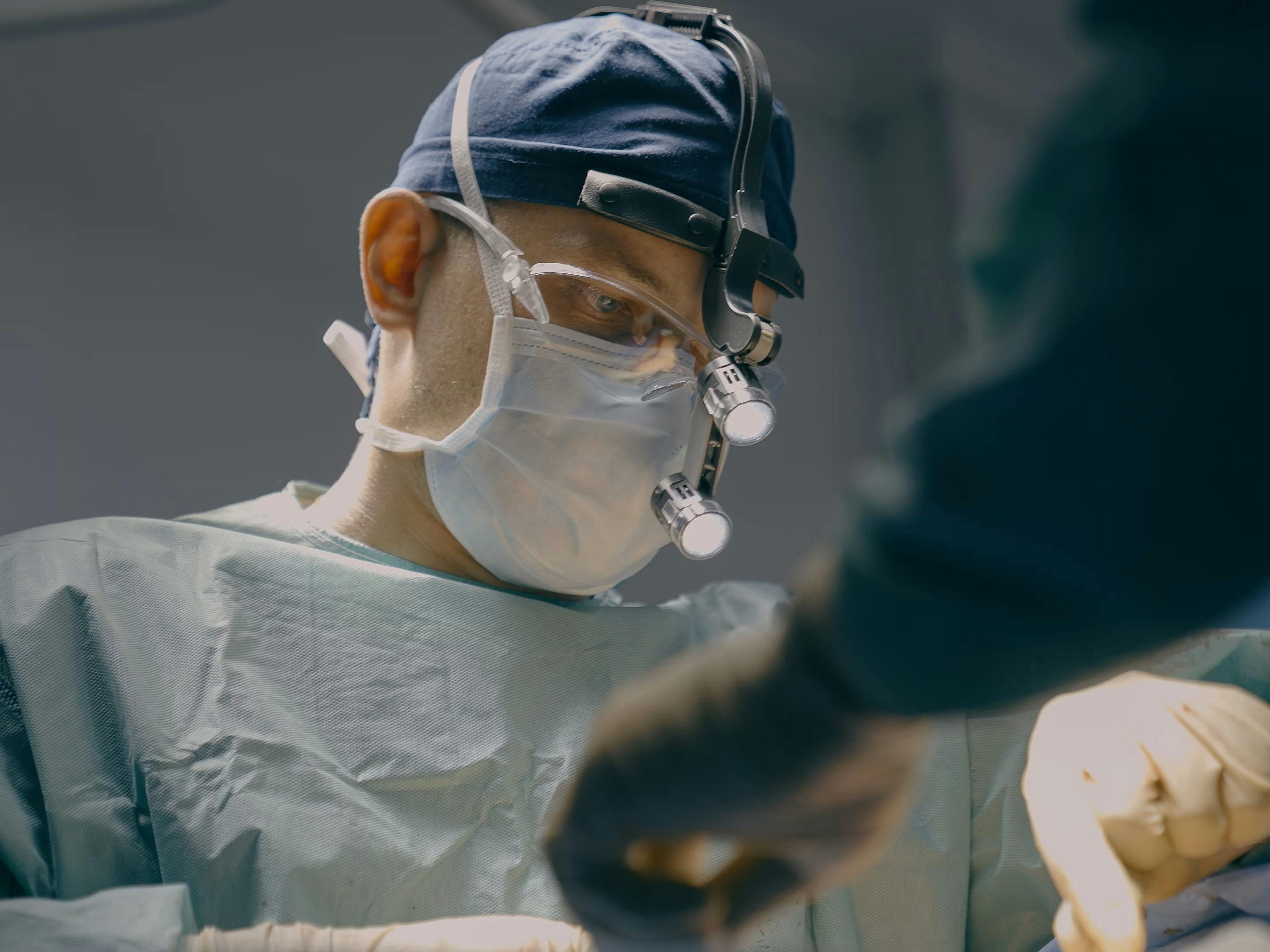 Doctor performing surgical procedure.