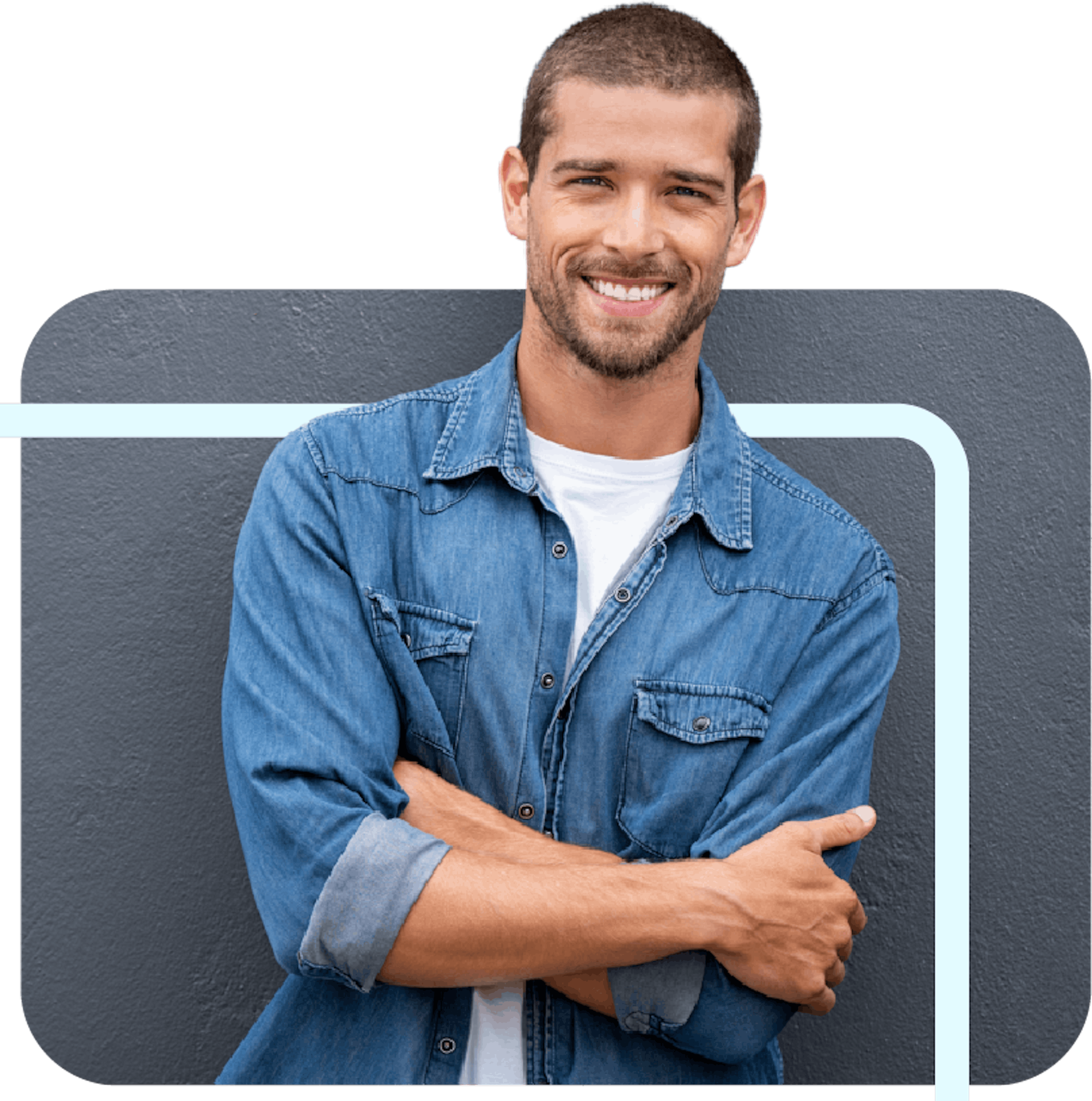 A young man smiling and crossing his arms.