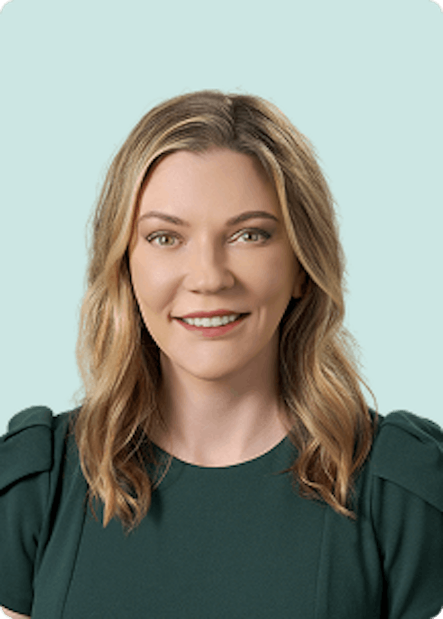 CLS Health's COO, Misty Berger, posing for her headshot in a dark green blouse.
