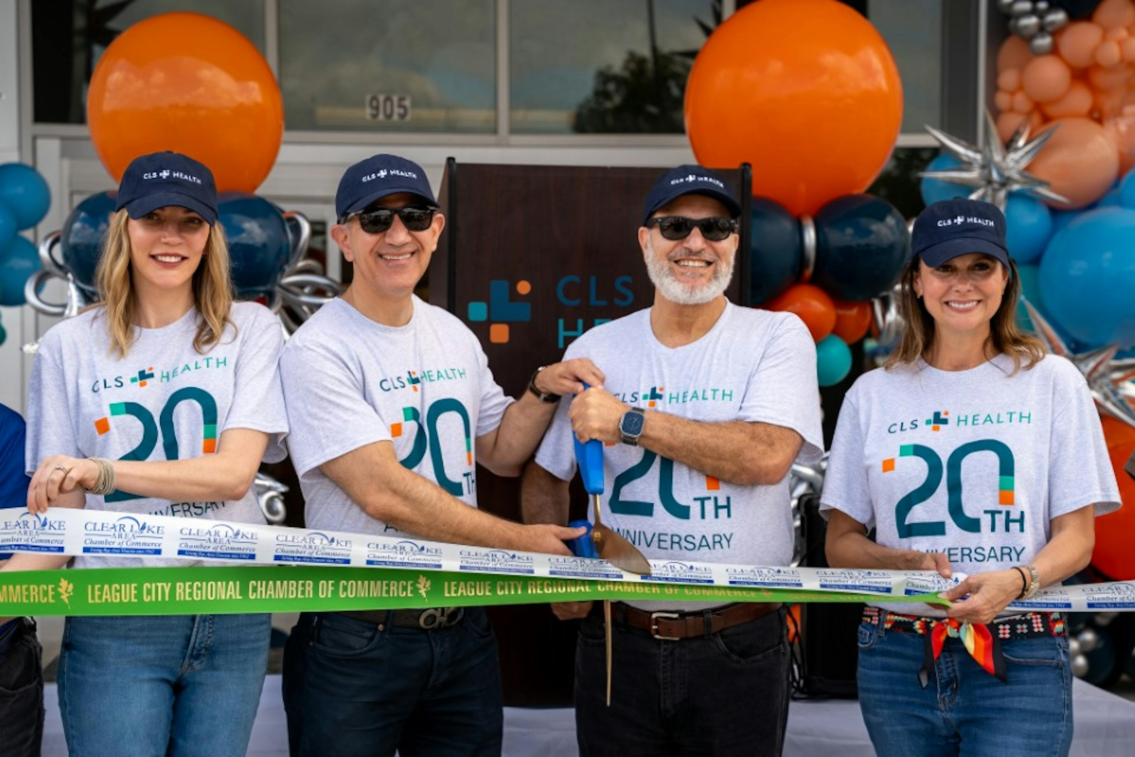 Dr. Baba, President, Dr. Dweik, Vice President, Megan Owen, CEO, and Misty Berger, COO, posing for a ribbon cutting to celebrate CLS Health's 20th anniversary.