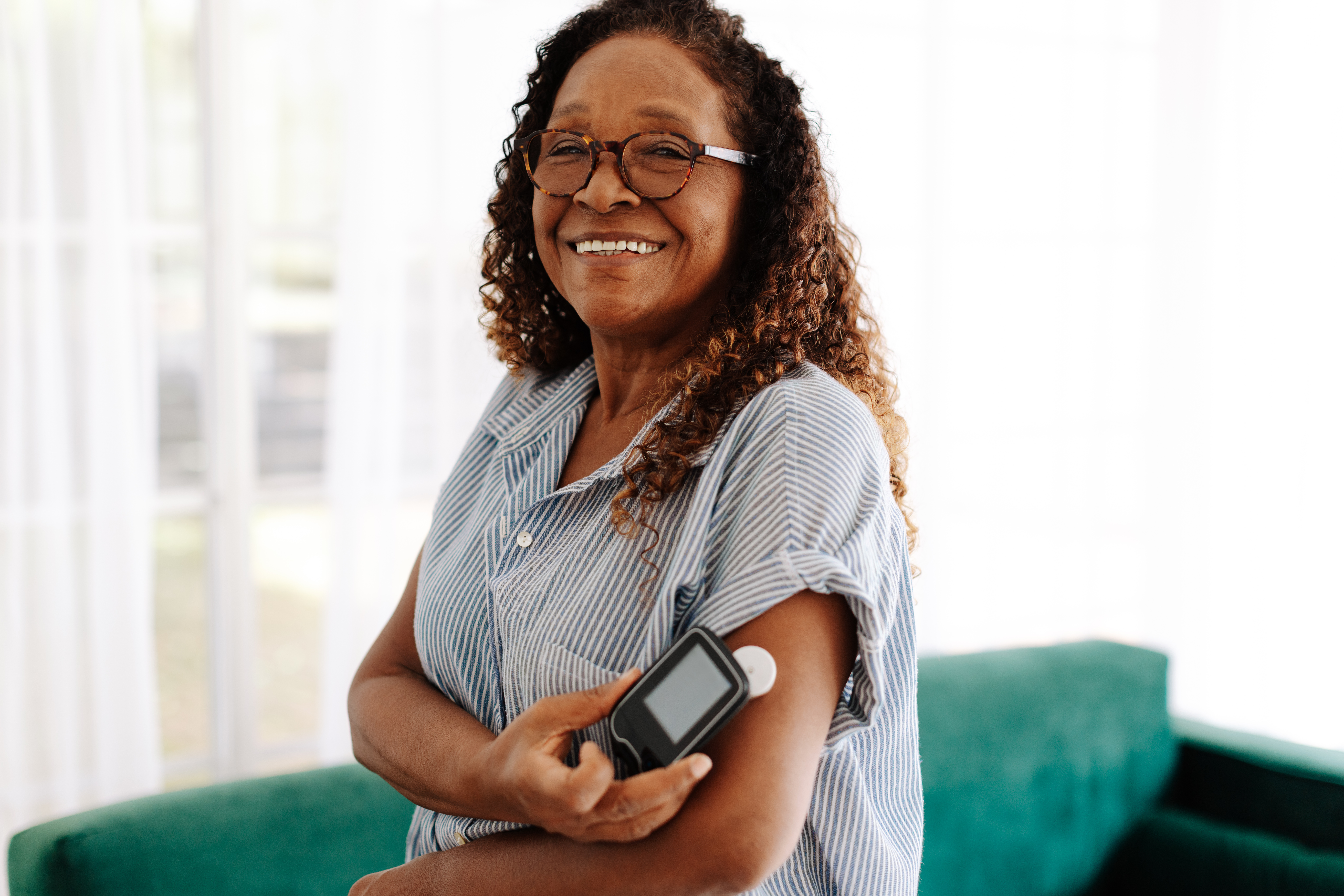 A woman is monitoring her diabetes with a glucose monitor. 
