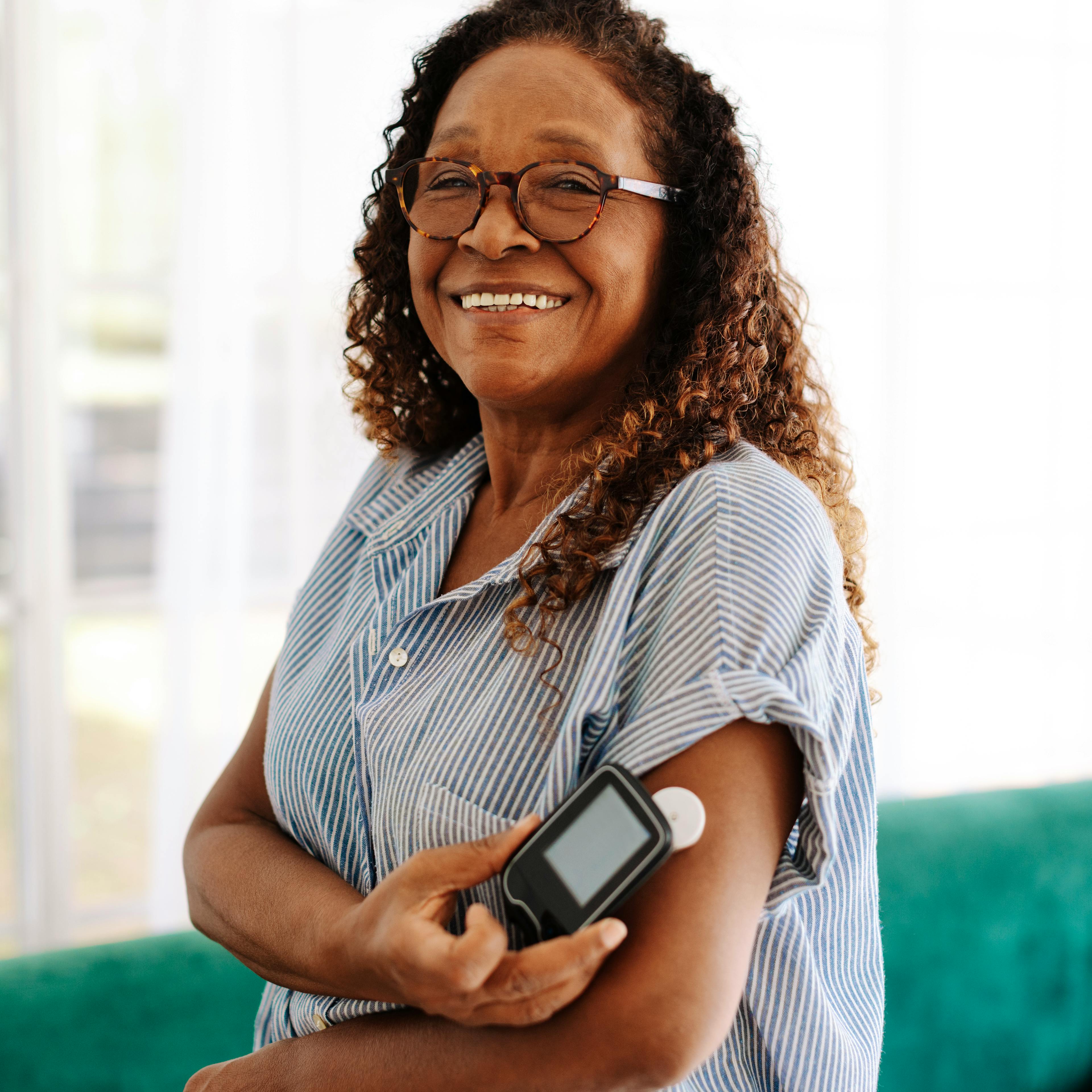 A woman is monitoring her diabetes with a glucose monitor.
