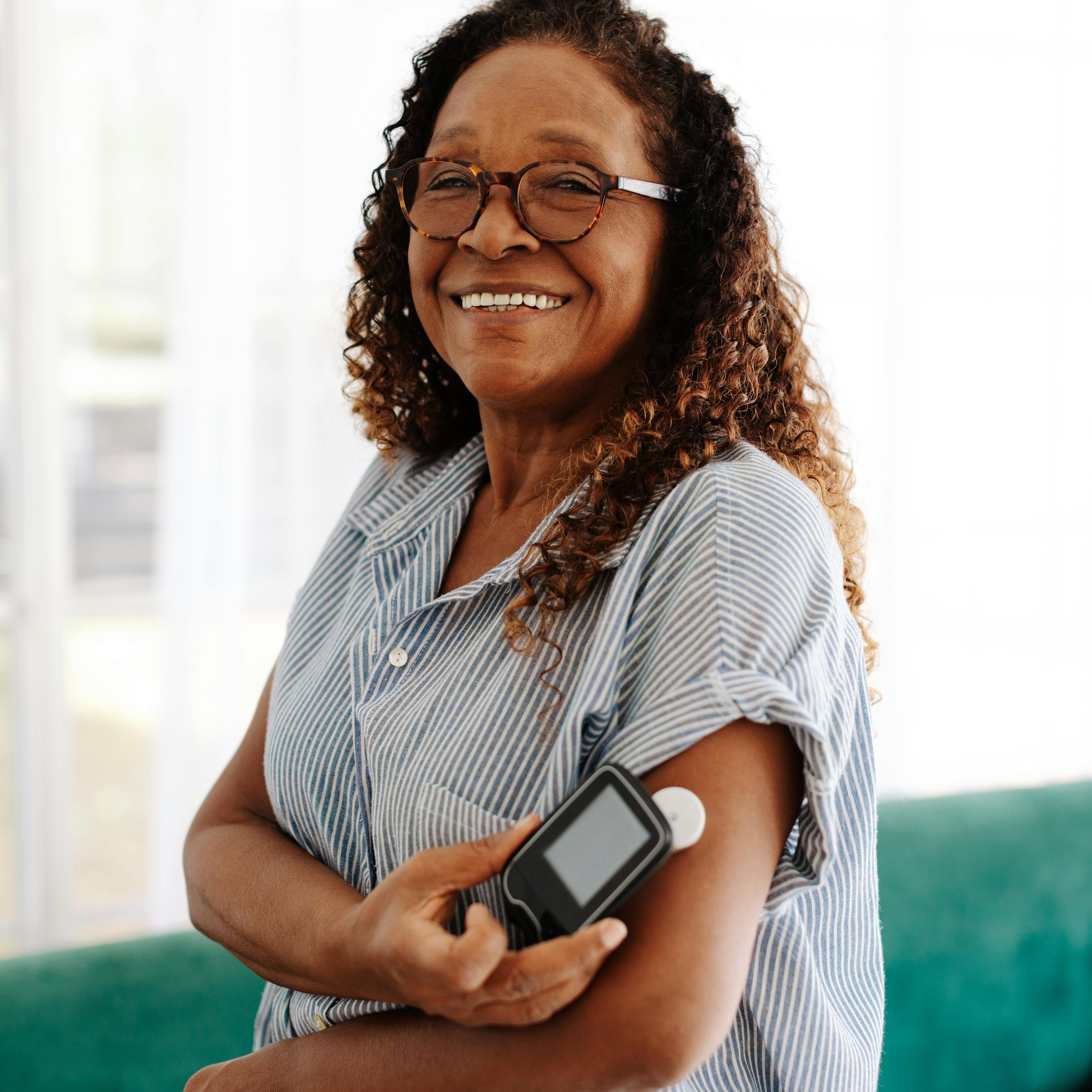 A woman is monitoring her diabetes with a glucose monitor. 
