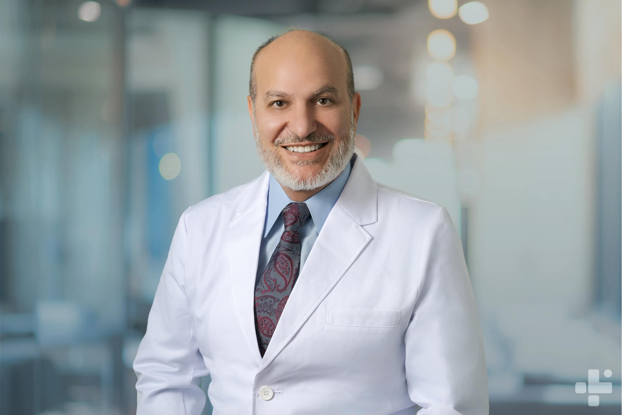 President of CLS Health, Mohammad J. Baba, MD, in his white coat.