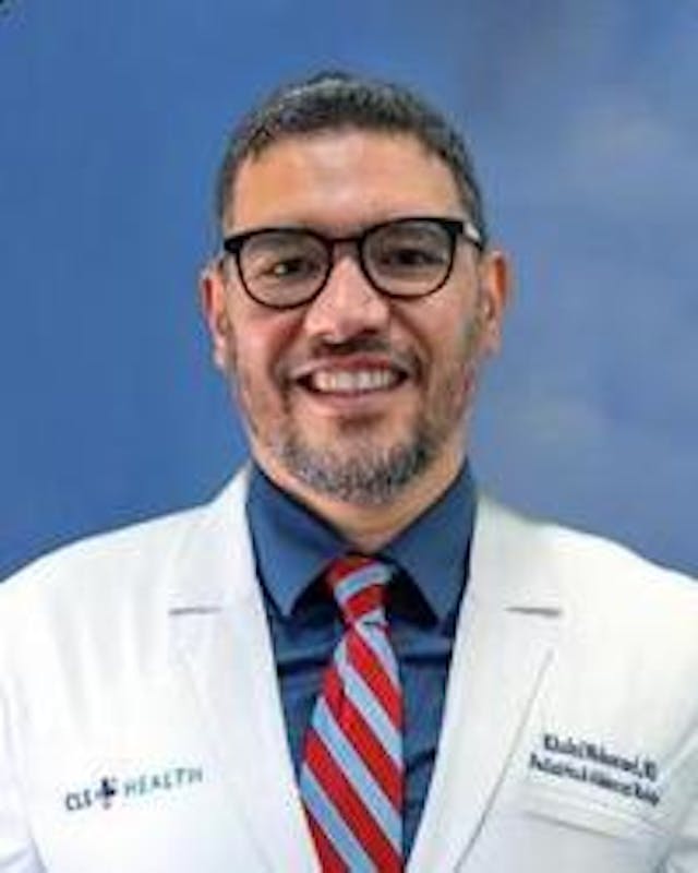 Sugar Land pediatrician, Khaled Mohammed, MD, posing for his headshot in his white coat. 