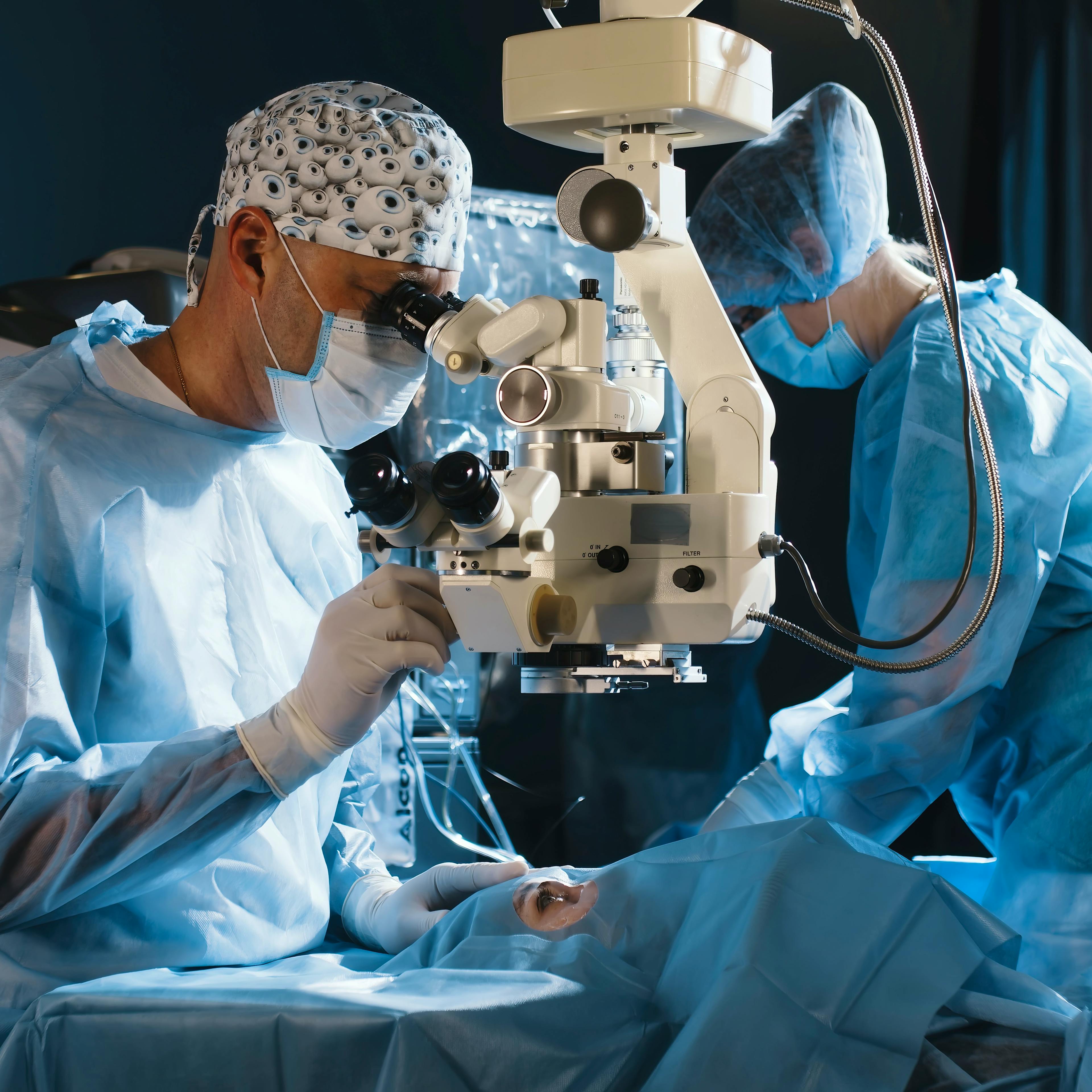 An ophthalmologist is performing eye surgery on a patient.