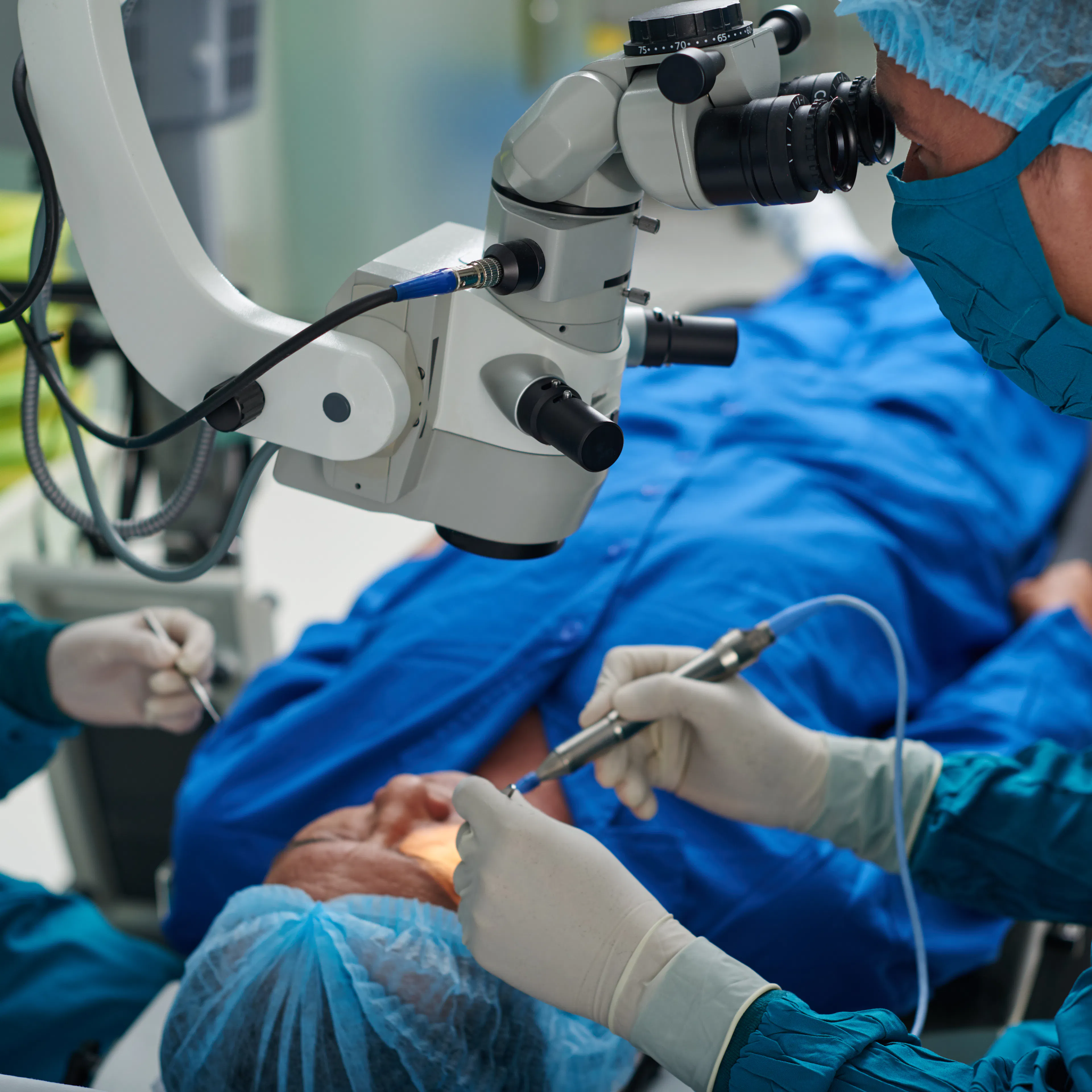 Ophthalmologists are performing eye surgery on a patient.