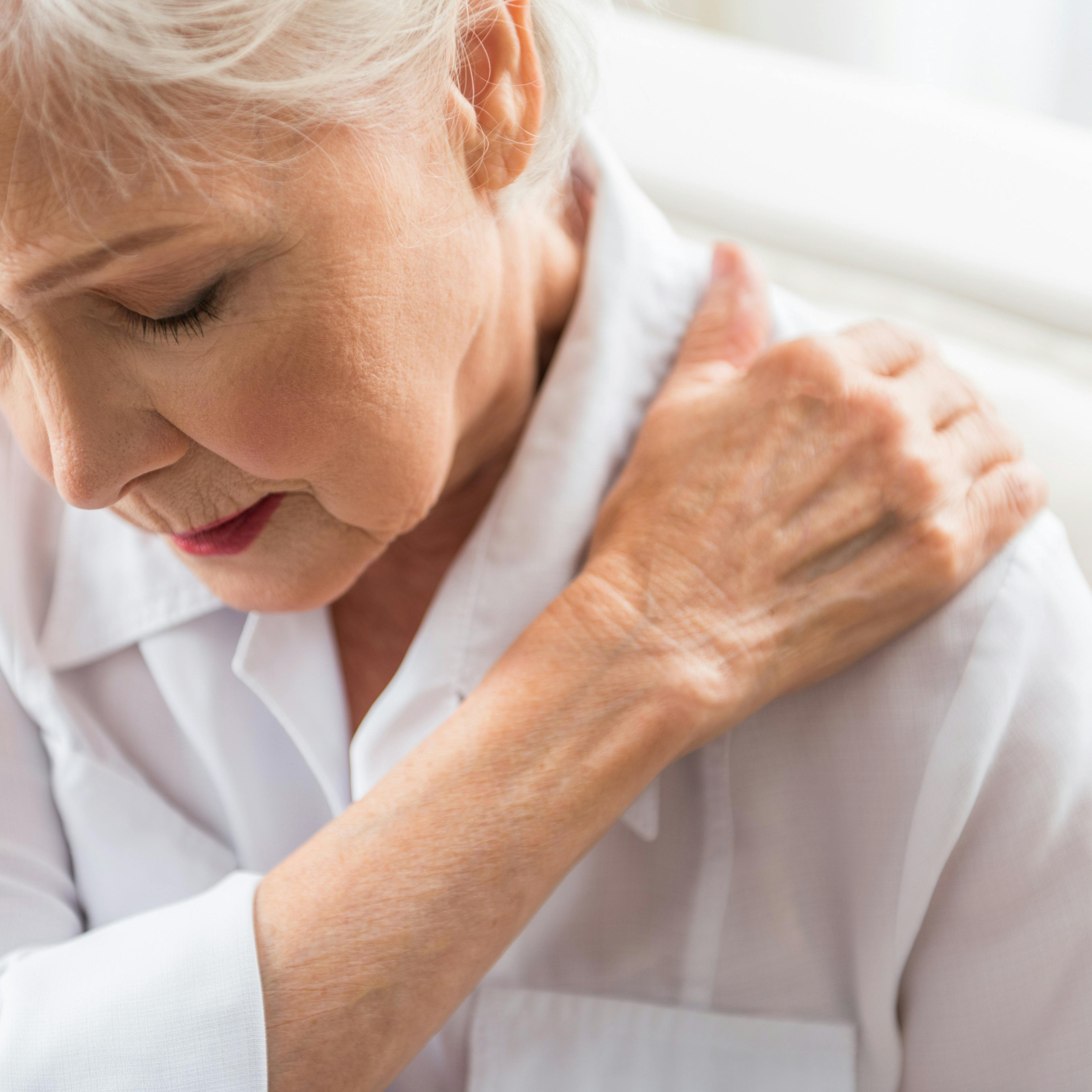 An elderly woman is experiencing shoulder pain.