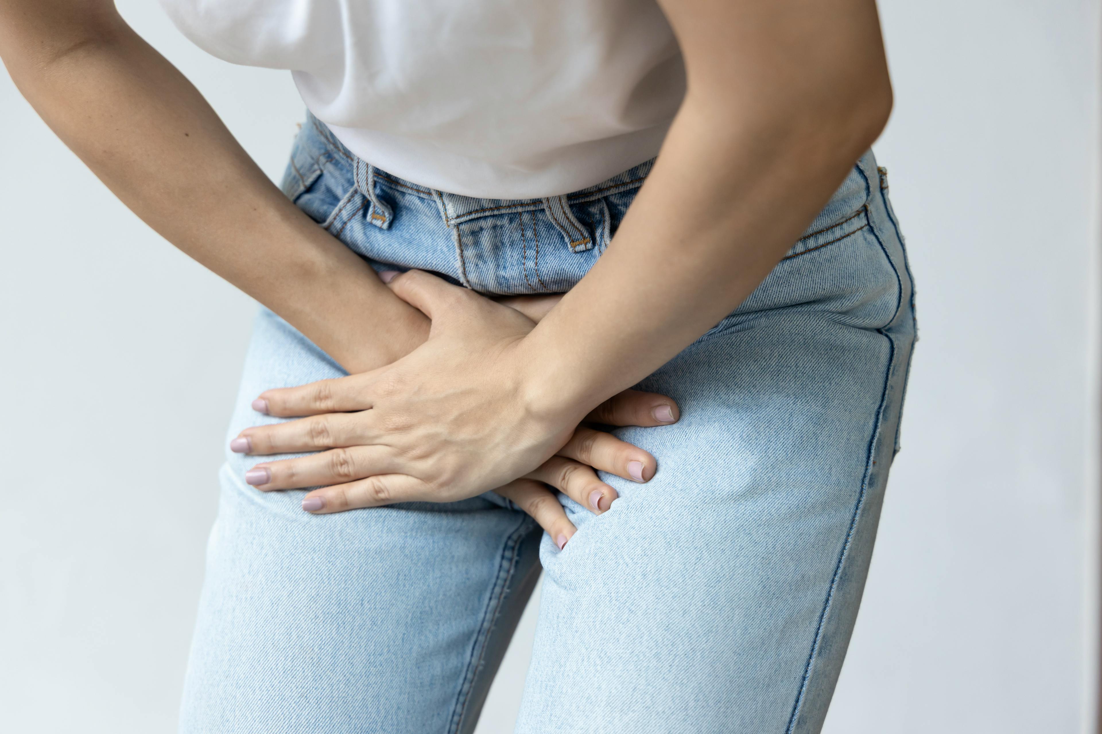Woman holding her pelvic region in pain