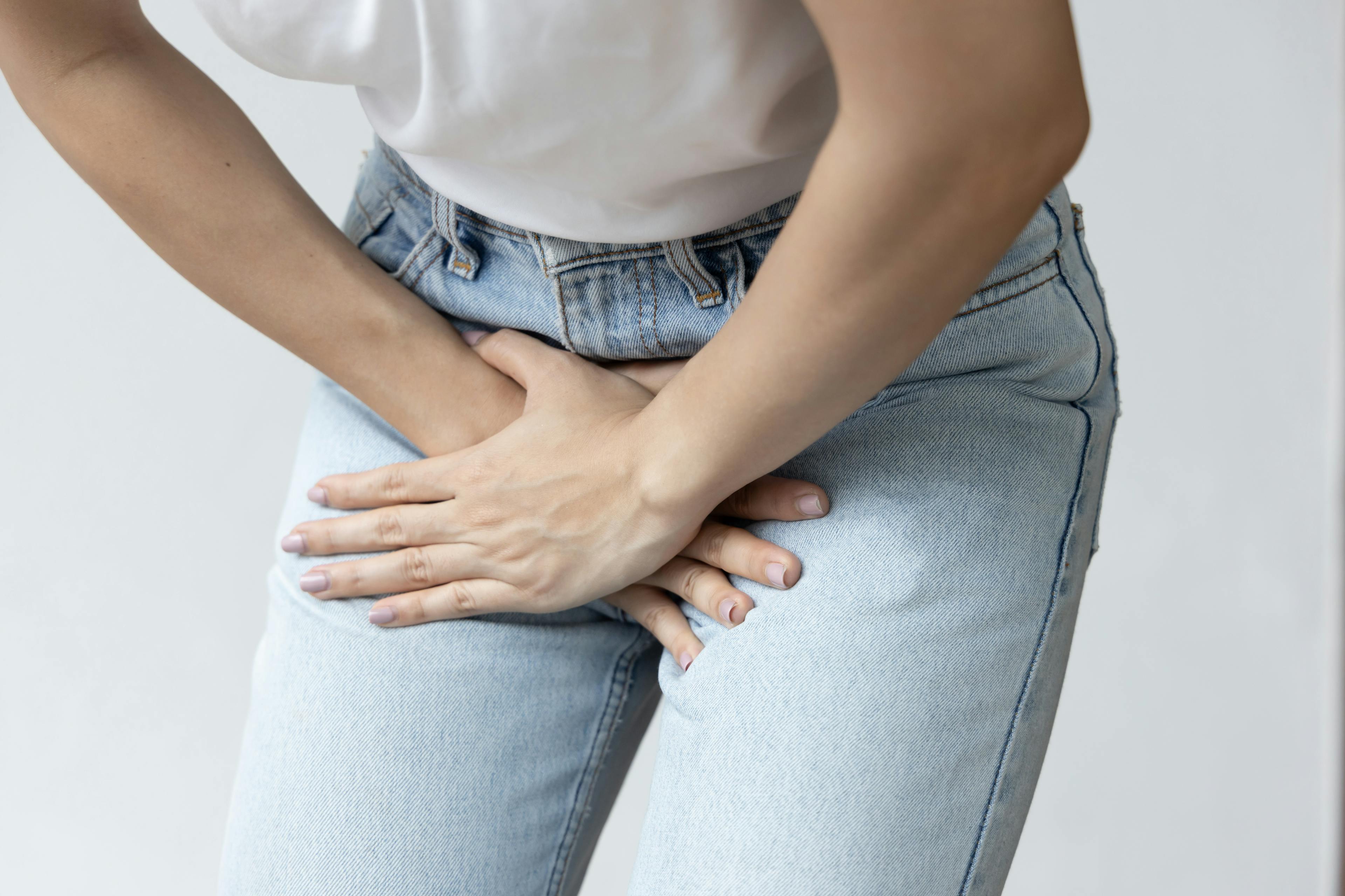 Woman holding her pelvic region in pain