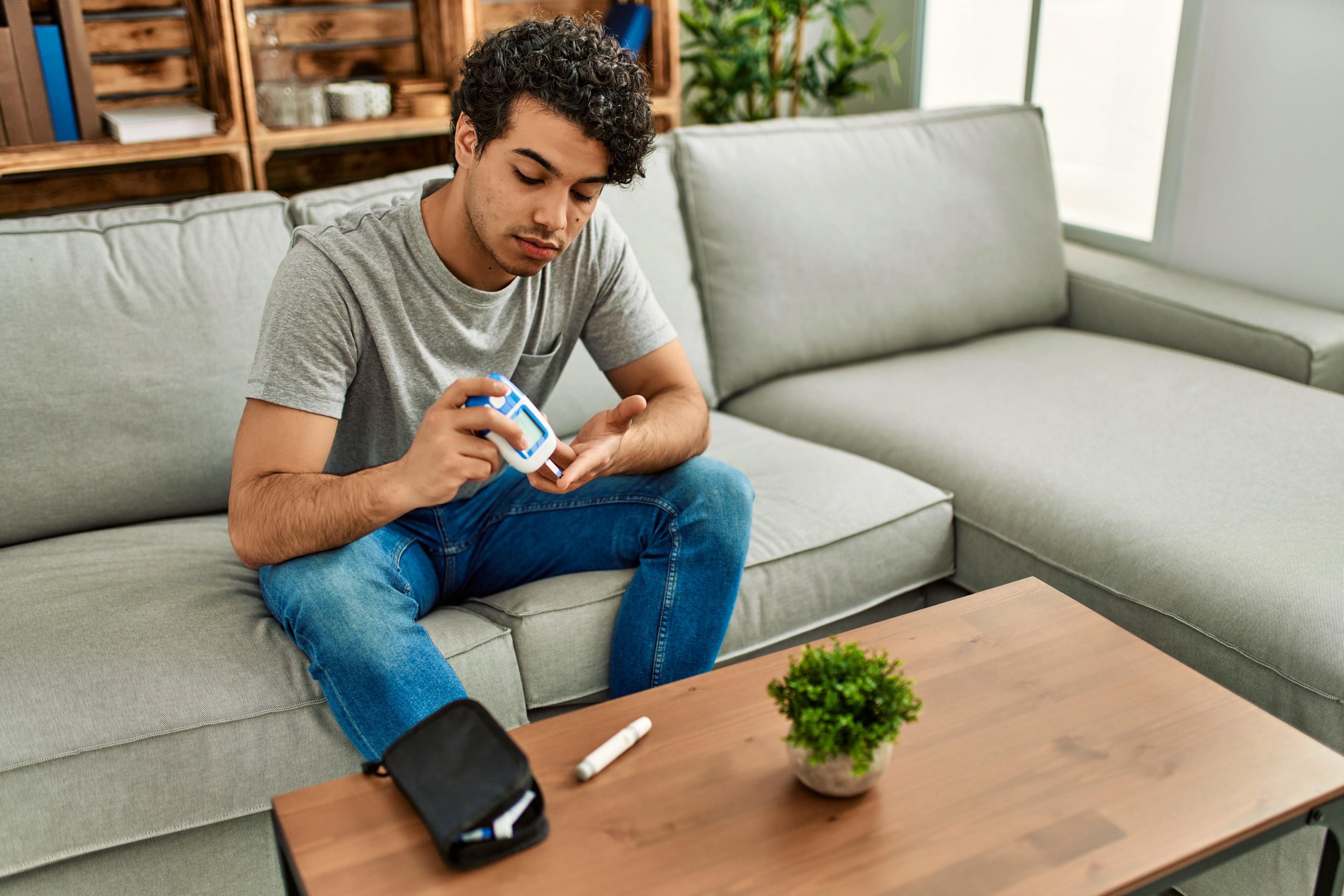 Young man checking his blood sugar levels