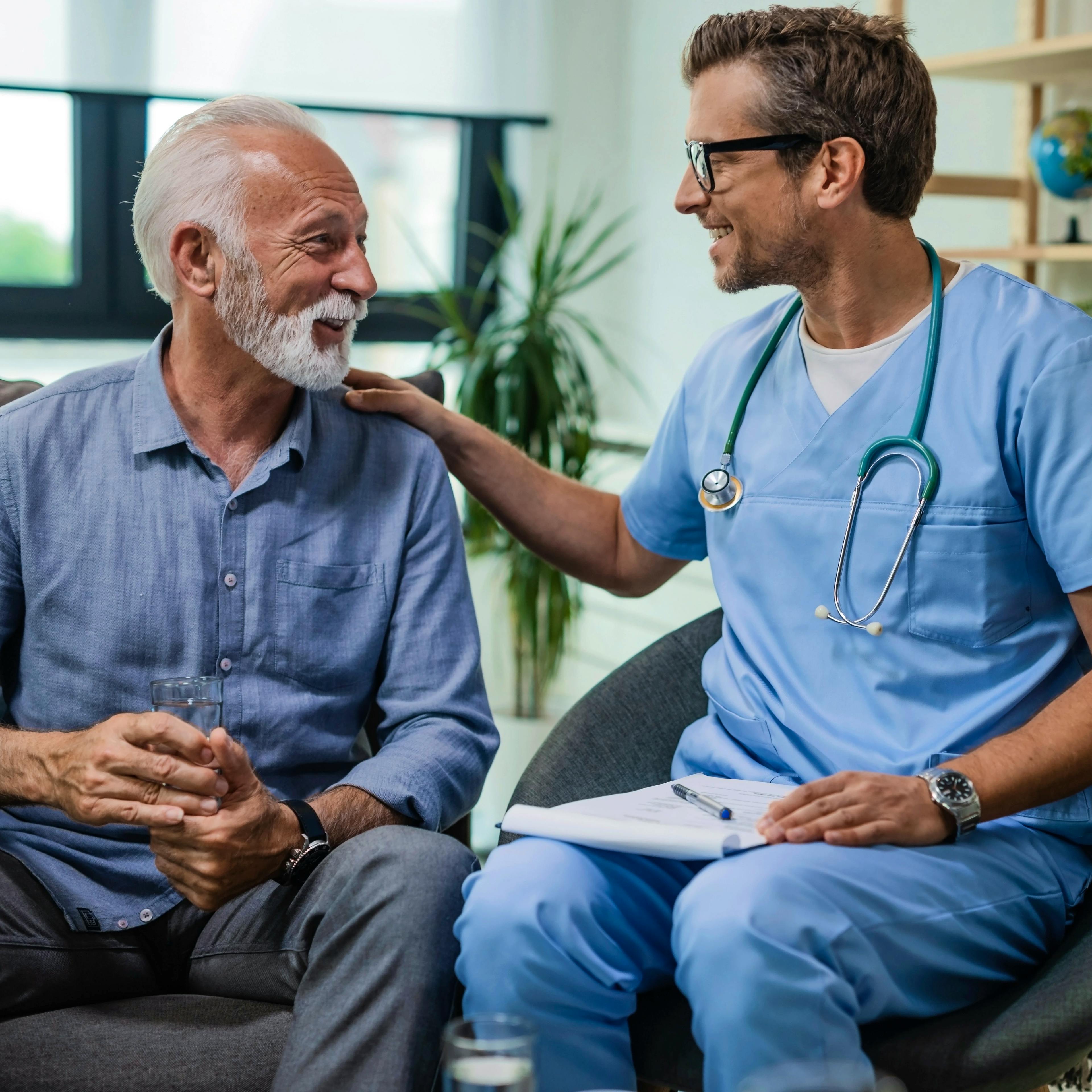 A doctor with his elderly male patient providing guidance and care.