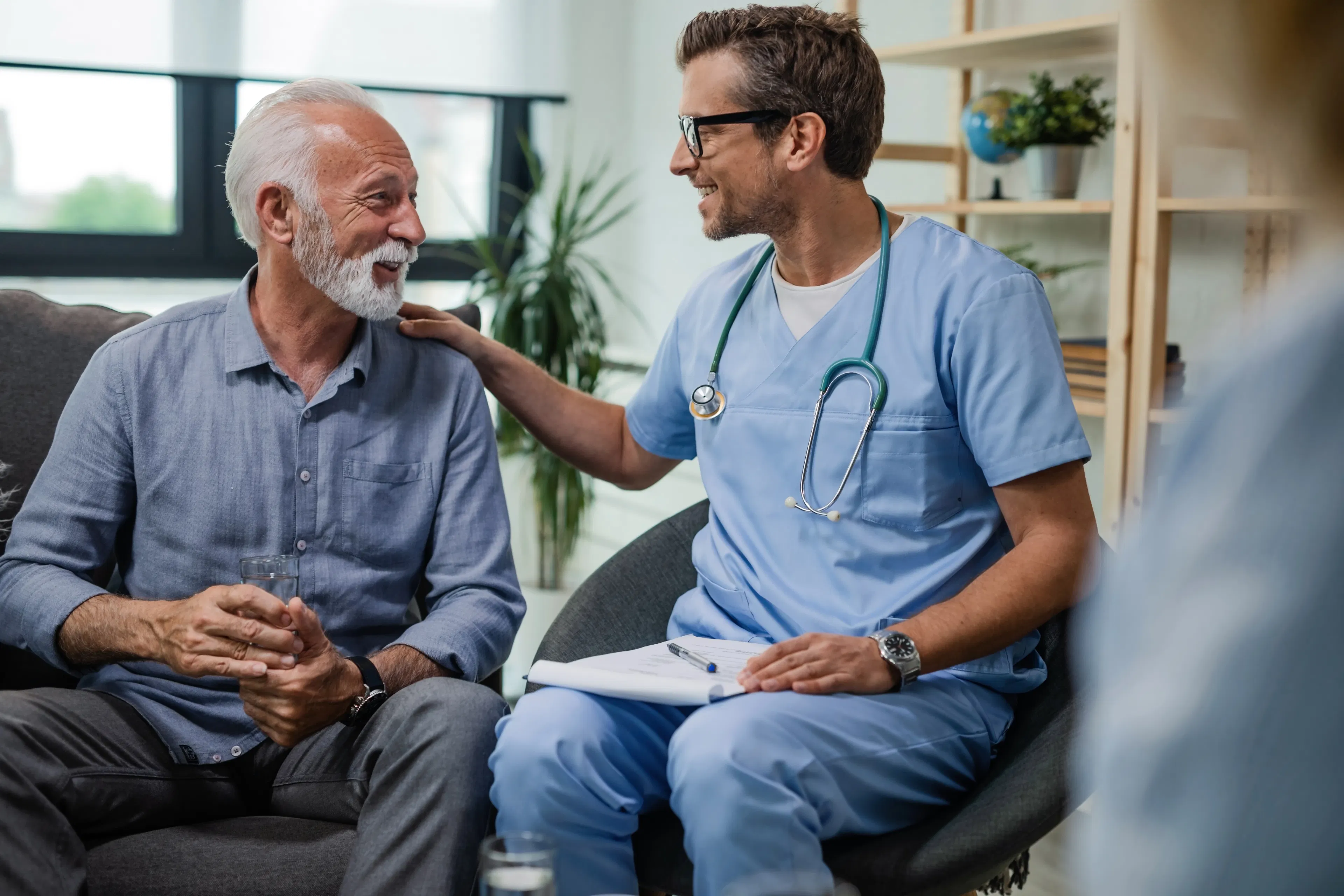 A doctor with his elderly male patient providing guidance and care.