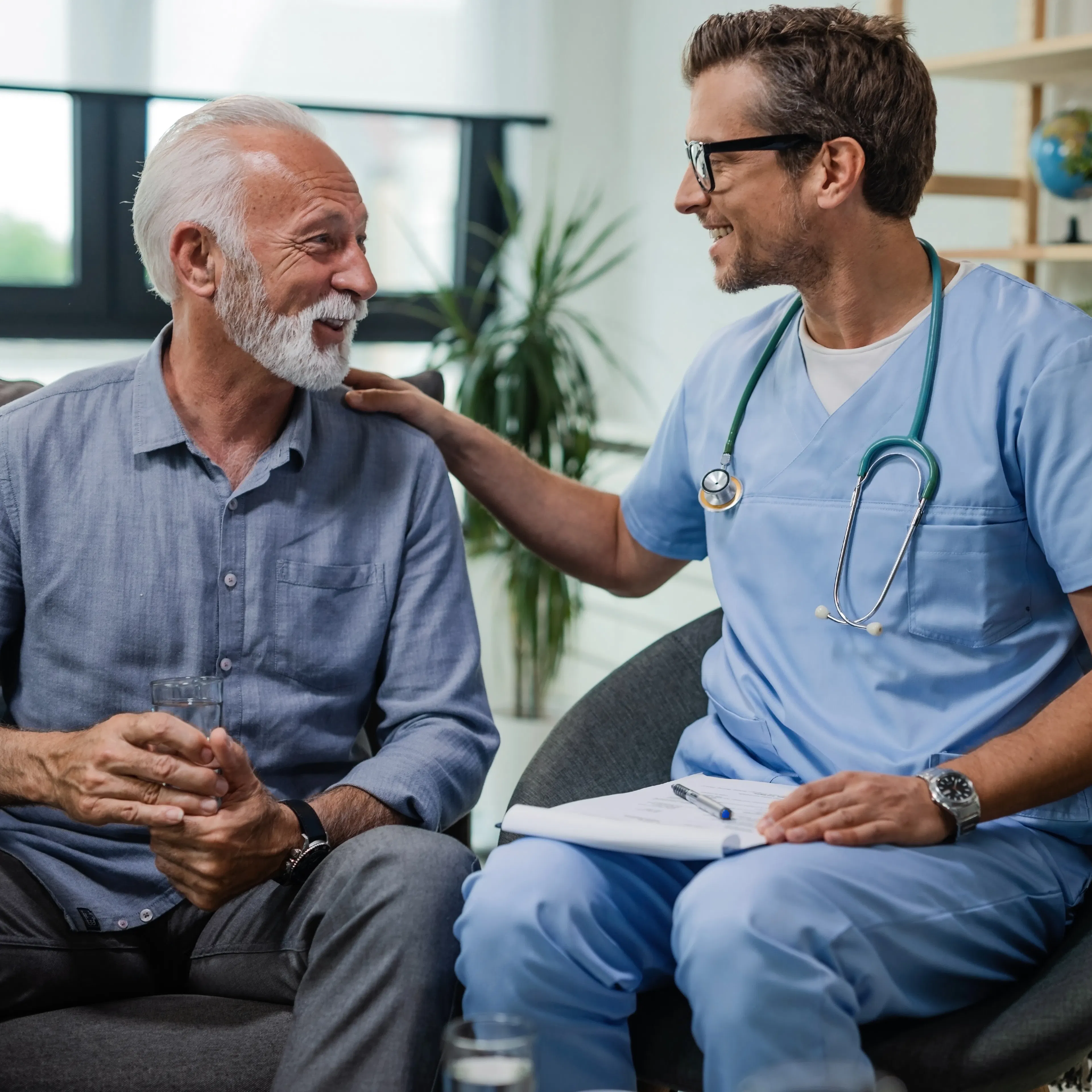 A doctor with his elderly male patient providing guidance and care.