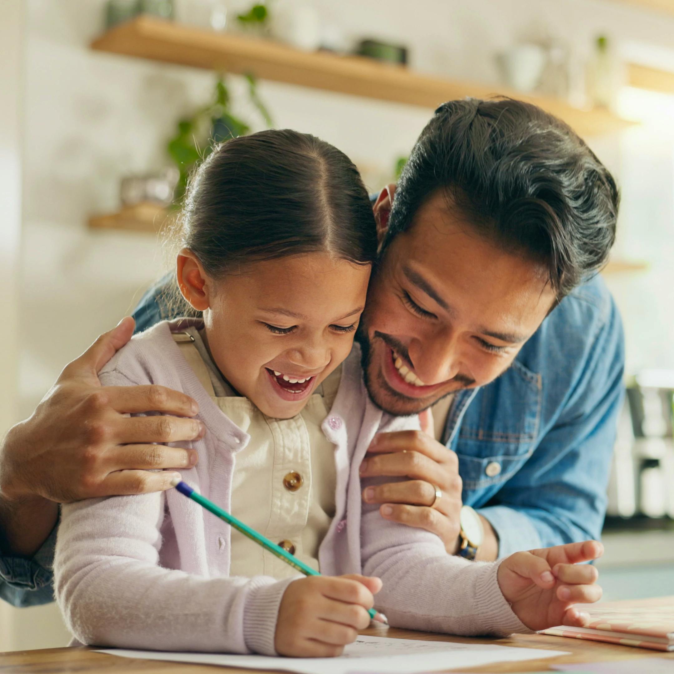 A young girl and her father are happily doing homework together with excitement.