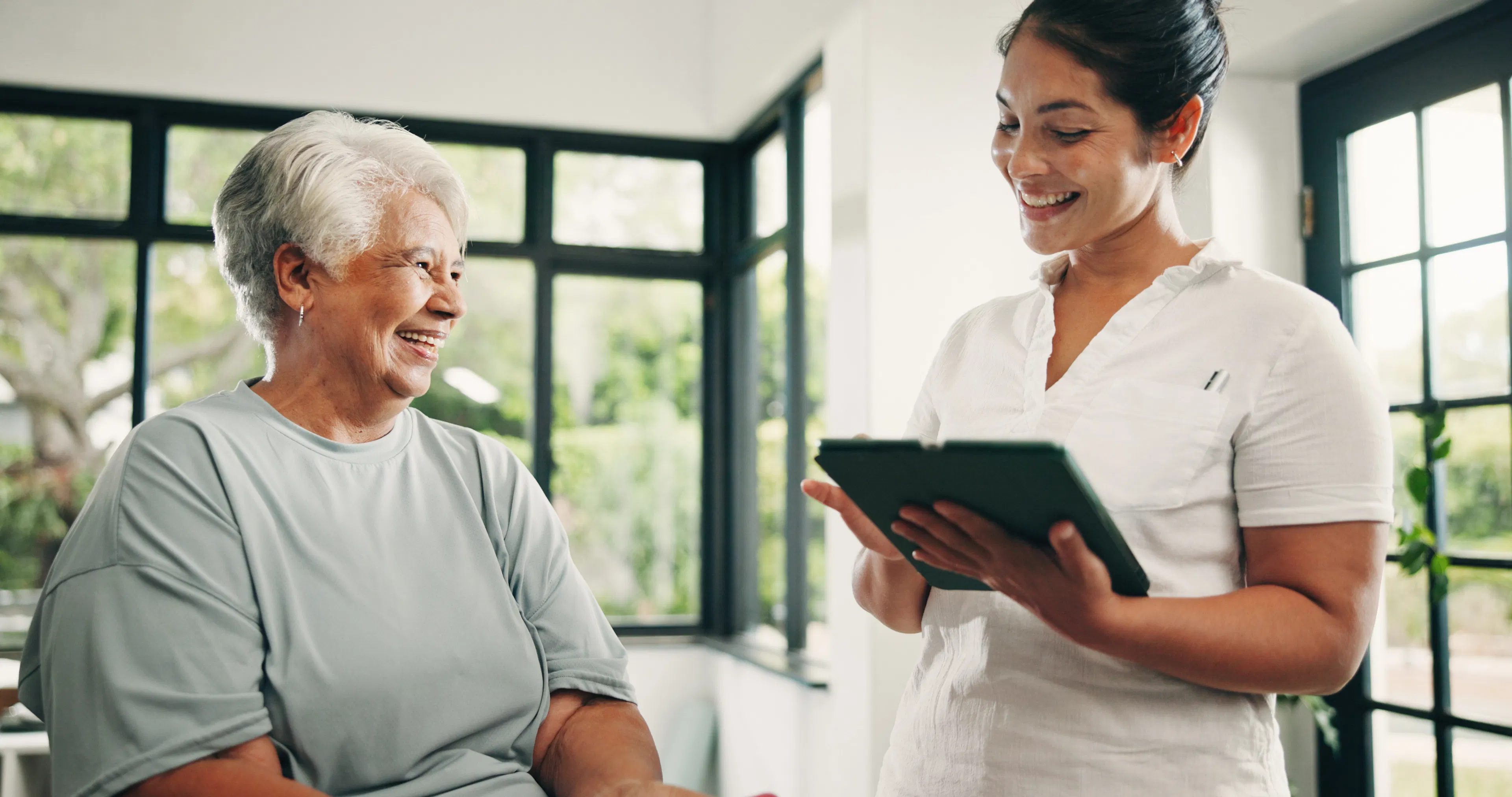 A nurse is walking a patient through their privacy policy using a tablet.
