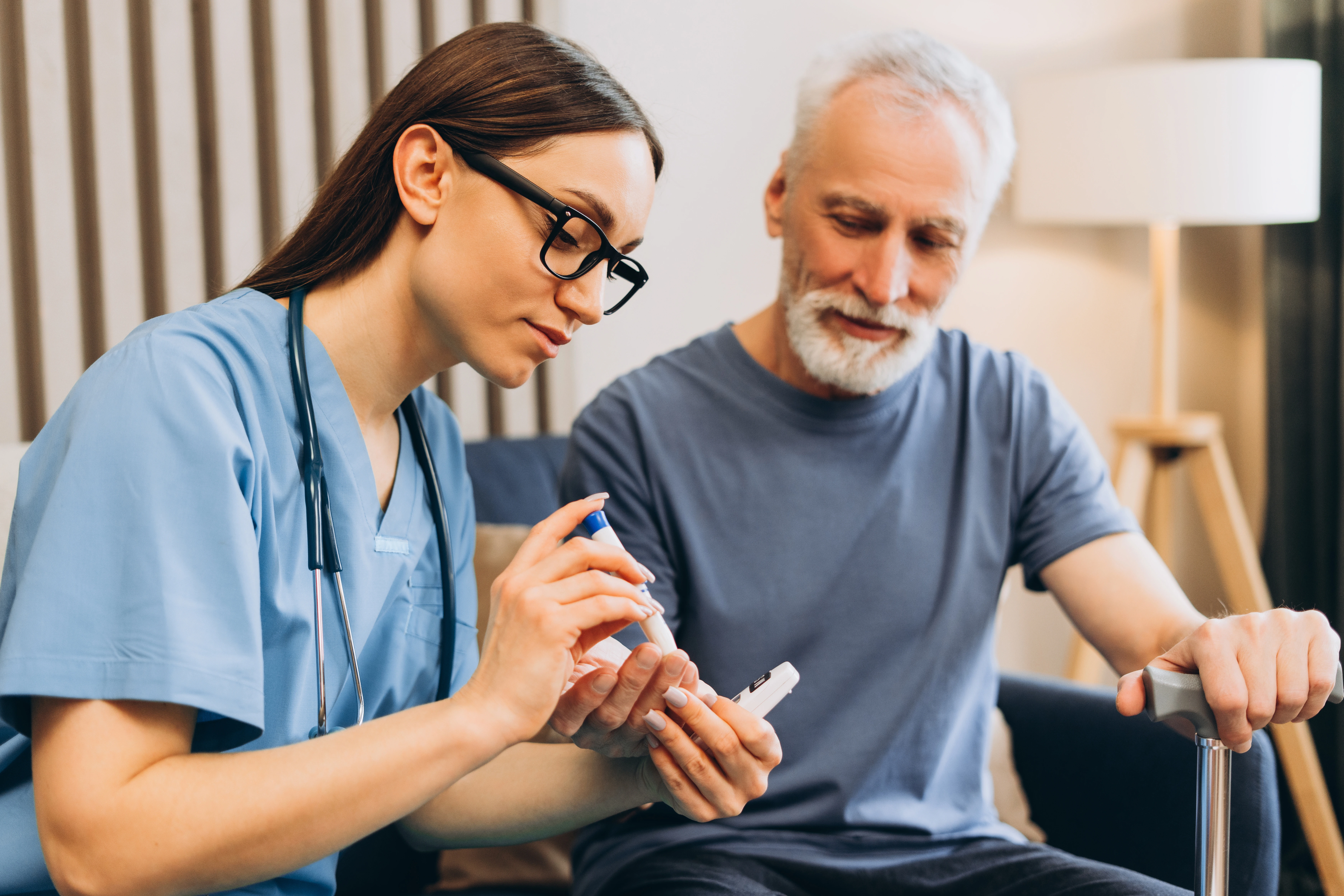 An endocrinologist is helping a patient check their blood sugar to manage diabetes.