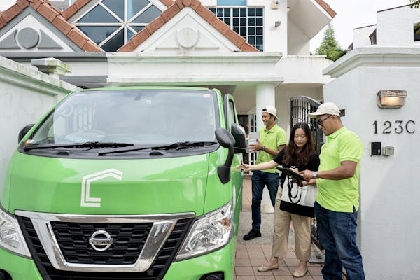 Our operations team, Claudia, Zul and Yusof, next to our green Casa Mia van in front of our Whitley home